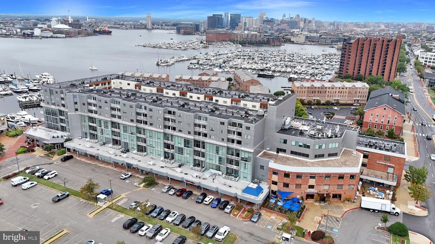 Welcome to resort-style living at Canton’s Waterfront! This contemporary two-bedroom, two-bathroom condo offers a luxurious lifestyle with stunning water views visible from the private balcony and nearly every room. The home features a bright, open floor plan with LVP flooring throughout the main living area and cozy carpeting in the bedrooms. The primary bedroom includes an en-suite bathroom, and both bedrooms boast large walk-in closets for ample storage. Recent upgrades include a smart thermostat, a new dishwasher (2024), and a hot water heater (2020).  Residents enjoy a wealth of amenities, including a front desk concierge, 24-hour security, and a gated community, along with the convenience of Lighthouse Canton wine, liquor, and deli located on the first floor. Fitness enthusiasts will appreciate the two on-site fitness centers. Parking is hassle-free with a deeded garage spot and plenty of street parking for guests. The condo offers easy access to I-95, 895, and 83. Plus, it's pet-friendly and within walking distance to Canton and Fells Point's finest local dining, bars, grocery stores, and boutique shops.
