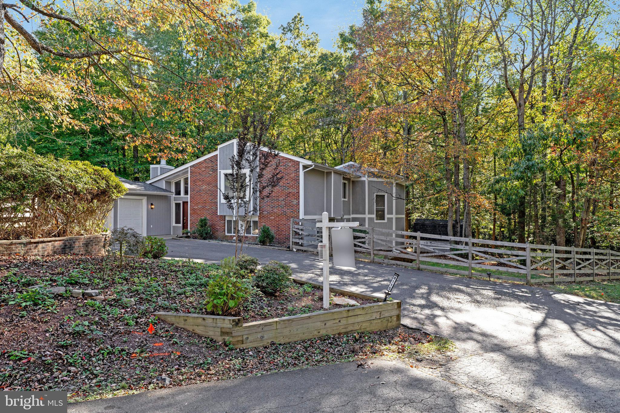 Kitchen light fixtures being replaced this week! Pet friendly and available for immediate occupancy!
Set deep into a quiet no-thru street in Camelot, this contemporary-style home feels like a private retreat—completely reimagined inside and out. Every corner of this property has been refreshed, offering a move-in-ready lifestyle without sacrificing proximity to Manassas conveniences.
With 2,454 finished square feet across three levels, this home blends striking architecture with thoughtful updates. The exterior has been given new life with fresh paint, detailed trim work, and updated landscaping that beautifully frames the wooded, nearly one-acre lot. A new roof (less than one year old) and replaced deck stairs add to the home’s worry-free appeal.
Step inside to find brand-new flooring and freshly painted interiors that make the home feel bright, clean, and modern. The soaring ceilings, generous windows, and stone-wrapped fireplace connect the living space seamlessly to its natural surroundings, while hardwood tones add warmth and character.
Upstairs, the updated kitchen features stainless steel appliances, granite counters, and a breakfast bar that opens to an airy loft—perfect for a lounge, studio, or home office. Sliding glass doors lead to an expansive upper deck, creating an effortless indoor-outdoor flow for entertaining or quiet mornings with coffee.
Each bedroom includes its own en-suite bath, offering privacy and convenience. The primary suite features a spacious walk-in closet and a bath with a soaking tub, double vanity, and separate shower.
The property’s outdoor living is just as impressive: fully fenced with new vapor barriers in both crawlspaces, revitalized landscaping, and a charming gazebo surrounded by mature trees. Two levels of decks invite you to enjoy the serene, wooded backdrop all year long.
Practical perks make this lease even more attractive—trash is included in the rent for full-price lease offers, keeping your weekends free to enjoy the peaceful surroundings. The oversized two-car garage, paved driveway, and mudroom access add daily convenience, and with no HOA, you’re free to enjoy the space your way.
From cozy evenings by the fireplace to summer gatherings on the deck, this home offers the best of both comfort and craftsmanship—fully refreshed and ready for its next chapter.