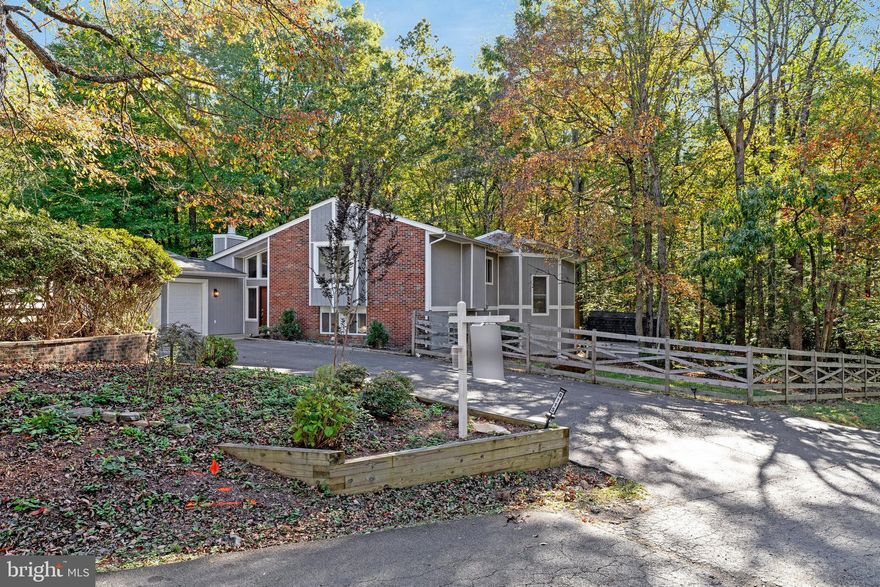 Kitchen light fixtures being replaced this week! Pet friendly and available for immediate occupancy!
Set deep into a quiet no-thru street in Camelot, this contemporary-style home feels like a private retreat—completely reimagined inside and out. Every corner of this property has been refreshed, offering a move-in-ready lifestyle without sacrificing proximity to Manassas conveniences.
With 2,454 finished square feet across three levels, this home blends striking architecture with thoughtful updates. The exterior has been given new life with fresh paint, detailed trim work, and updated landscaping that beautifully frames the wooded, nearly one-acre lot. A new roof (less than one year old) and replaced deck stairs add to the home’s worry-free appeal.
Step inside to find brand-new flooring  and freshly painted interiors that make the home feel bright, clean, and modern. The soaring ceilings, generous windows, and stone-wrapped fireplace connect the living space seamlessly to its natural surroundings, while hardwood tones add warmth and character.
Upstairs, the updated kitchen features stainless steel appliances, granite counters, and a breakfast bar that opens to an airy loft—perfect for a lounge, studio, or home office. Sliding glass doors lead to an expansive upper deck, creating an effortless indoor-outdoor flow for entertaining or quiet mornings with coffee.
Each bedroom includes its own en-suite bath, offering privacy and convenience. The primary suite features a spacious walk-in closet and a bath with a soaking tub, double vanity, and separate shower.
The property’s outdoor living is just as impressive: fully fenced with new vapor barriers in both crawlspaces, revitalized landscaping, and a charming gazebo surrounded by mature trees. Two levels of decks invite you to enjoy the serene, wooded backdrop all year long.
Practical perks make this lease even more attractive—trash is included in the rent for full-price lease offers, keeping your weekends free to enjoy the peaceful surroundings. The oversized two-car garage, paved driveway, and mudroom access add daily convenience, and with no HOA, you’re free to enjoy the space your way.
From cozy evenings by the fireplace to summer gatherings on the deck, this home offers the best of both comfort and craftsmanship—fully refreshed and ready for its next chapter.