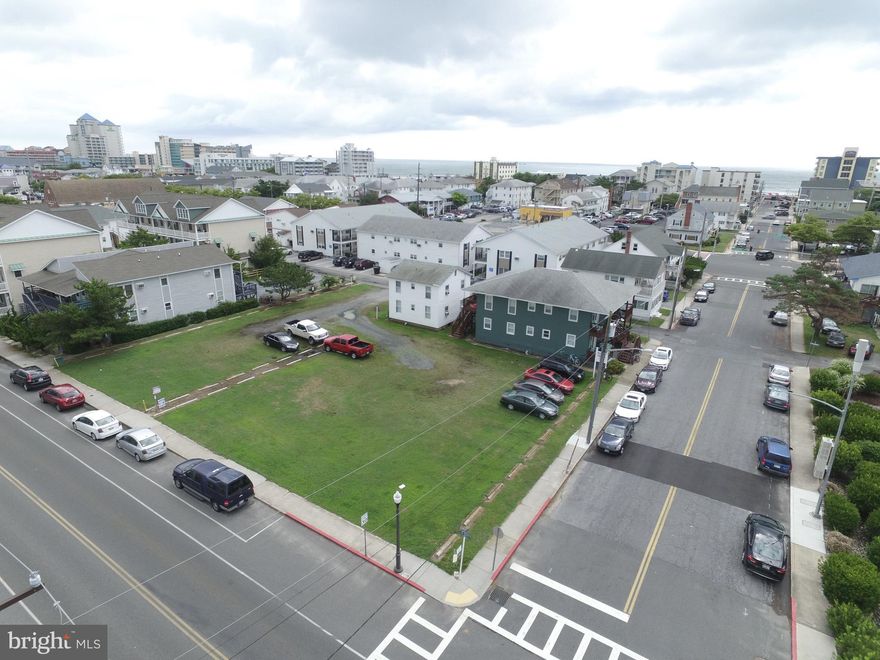 This listing comprises of a total of 21300 sq. ft.  of  FEE SIMPLE land in the heart of Downtown Ocean City.  Included in this sale is two buildings.  The front building housed (4) 2 bedroom 1 bath units with hardwood floors central air, wash/dryer, while the back building houses (2) 2 bedroom one bath units with baseboard heat, hardwood floors and washer/dryer.  These units currently have a GRI of $69,000 for 2018.  Also included in this listing are 3 vacant lots that can be used for parking or for development potential.    Lots are comprised of the following sizes.  4600, 5000, & 7100 Sq ft.  Lots can remain separate, or be combined to   form a much larger building envelop.  8-10 town homes can be built on the property depending on design and use.  Please watch attached video for location and proximity views.