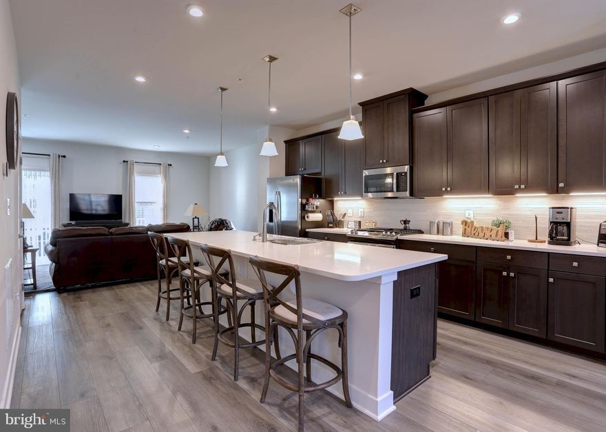 JUST REDUCED!!! Stunning 2-Year-Old End Unit Townhouse with Premium Amenities near DC!
Welcome Home to this immaculate and modern 3-bedroom, 2.5-bathroom end unit townhouse, perfectly situated for an easy commute to Washington D.C. and offering immediate access to all major highways! Built just two years ago, this home combines contemporary design with premium community amenities.
Key Features Include:  
Open Concept Living: The main level boasts a bright, airy, and expansive open floor plan, perfect for entertaining and modern living.
Gourmet Ready: Enjoy cooking and gathering with beautiful hardwood floors extending throughout the entire main level.
Outdoor Living: Step out onto your private deck for morning coffee or evening relaxation.
Finished Walk-Out Basement: The lower level features a spacious walk-out basement family room, offering flexible space for a media room, home office, or gym, and leads directly to outdoor space.
Parking & Storage: Convenient and secure garage parking provides protection from the elements and extra storage space.
Luxurious Primary Suite: The upper level features three comfortable bedrooms, including the private Primary Suite complete with a spa-like primary bathroom featuring a separate soaking tub and shower.
Convenience: A total of 2 full baths and 1 half bath, providing convenience for residents and guests.
Community Amenities: Enjoy an active lifestyle with fantastic community features right outside your door, including: Community Playground, Dog Park, Community Pavillion
Location, Location, Location:
Don't miss the opportunity to live in this sought-after community "The Towns at Westside" offering the ideal blend of tranquility and connectivity. Experience easy access to shopping, dining, and effortless travel to the greater D.C. Metropolitan area. This is the perfect blend of modern luxury and unbeatable location!
Schedule your showing today!