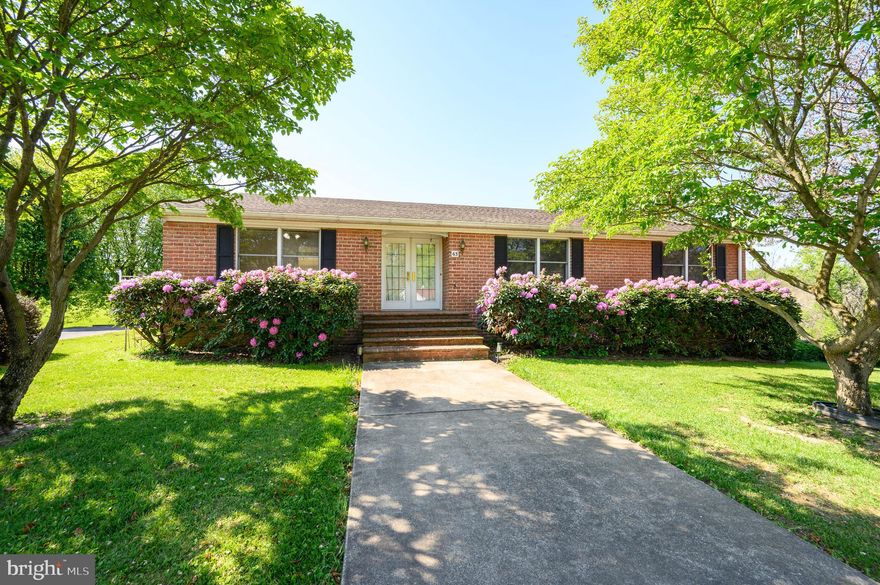 Welcome to your country estate featuring a charming home on scenic acreage. This well-maintained brick Foremost home was built in 1988 and is situated on approximately 6 acres which offers beautiful views of the woods, stream and quiet peaceful country living. All this is available in a rural private subdivision only minutes from town. Walk into an open foyer that leads you to a large eat-in kitchen, with a separate dining room, living room and family room.   The primary bedroom has en-suite relaxing jetted tub with separate shower, 2 other bedrooms with an additional bathroom.  Bring friends and family to enjoy the large, finished basement/recreation room and brick hearth.   Recreation room leads to the laundry room, with half bath, plus an entrance to a heated workshop (11 x 25) and heated two car garage. Amenities include spacious back deck with attached gazebo, brick BBQ pit, beautiful, landscaped yard with mature trees, flowers and plenty of space for a garden and other activities for the kids.  A metal storage building (14 x 24) and generous blacktop parking area complete the sprawling property.  Located with a close proximity to Rt. 340, Rt 9, Marc train and other commuter routes.   New heat Pump- 219--- New well pump and tank-2021. SCHEDULE YOUR PRIVATE SHOWING TODAY!