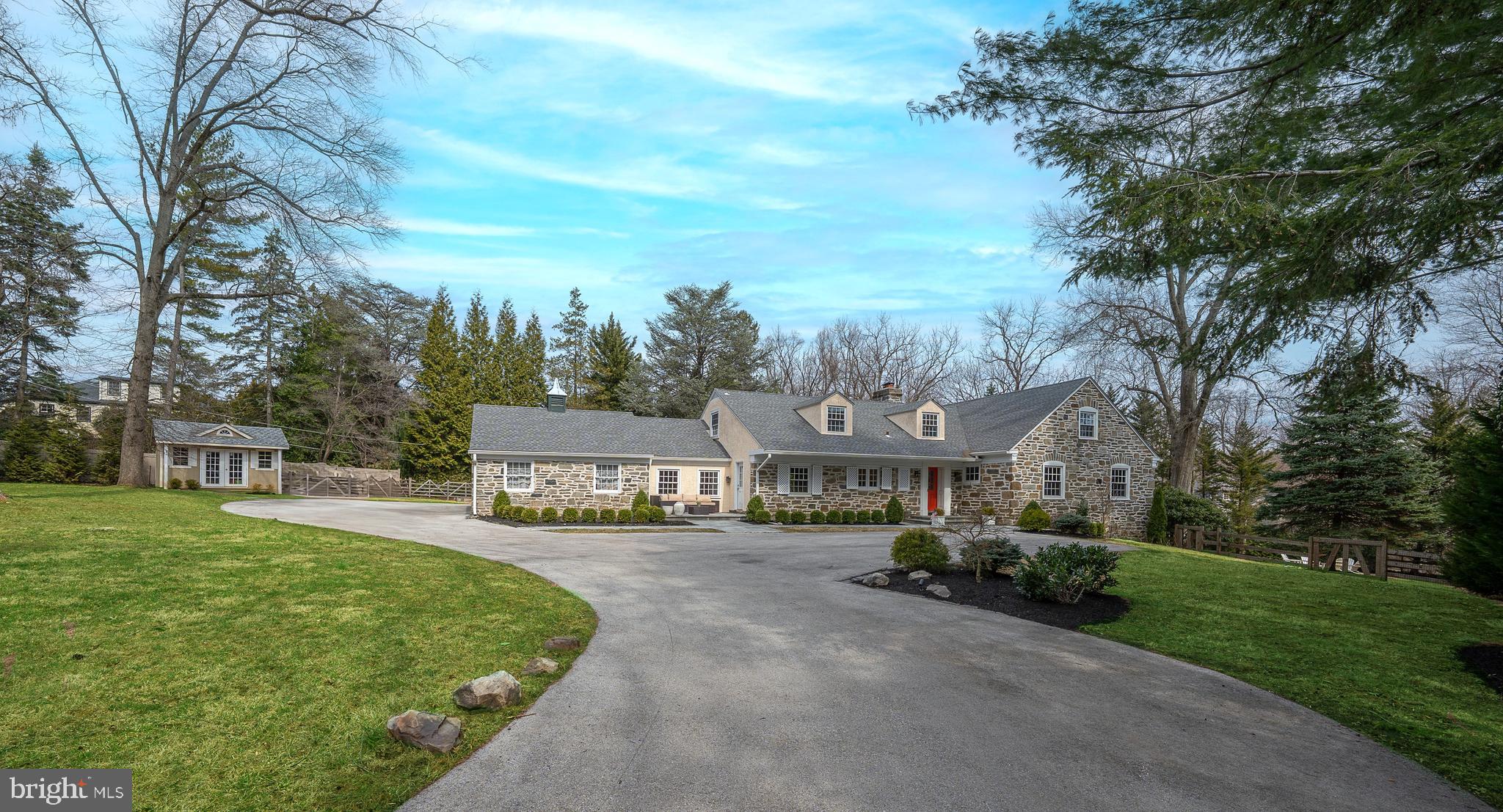 Welcome to this fabulous, renovated, 4000+ sq ft home located in the heart of Bryn Mawr. Offering 5 spacious bedrooms, 4 full bathrooms, and 2 half bathrooms, this home is the perfect blend of luxury and comfort. Situated on a beautiful interior and private lot, the property features a fabulous heated inground swimming pool, a fire pit, and a gazebo with a built-in BBQ and kitchen, creating your oasis for outdoor entertaining and relaxation. Step inside to find a thoughtfully updated, beautiful kitchen, which is complete with white wood cabinetry, quartz countertops and breakfast bar, stainless steel appliances, a spacious island with seating, and a sizeable convenient pantry. The open concept floorplan flows seamlessly into the bright dining area, and living room with chair-rail, crown molding, and a wood-burning fireplace, creating a welcoming atmosphere perfect for elegant and casual get-togethers. Sliders lead out to the tranquil paver patio, and gorgeous grounds ideal for indoor-outdoor living. Step down to the cozy family room just off the kitchen. The luxurious 1st-floor primary bedroom suite is a true retreat, featuring two custom, walk-in closets and a vast, updated ensuite bathroom with a double vanity, soaking tub, and shower. A versatile bedroom/office with another full ensuite bathroom, a bonus space and access to private deck makes the perfect in-law suite. A half bathroom completes the main floor. Upstairs, a private bedroom suite with a walk-in closet and complete bathroom offers added comfort and privacy, while two additional bedrooms share a beautiful full Jack and Jill bathroom. The finished lower level boasts a huge recreation room, half bathroom, laundry room, and plenty of storage, with an outside entrance for convenience. Additional features include a whole-house generator, new gutters, new roof, new windows, and new HVAC, ensuring comfort and peace of mind. A 2-car garage adds to the home's practicality. Located in a desirable neighborhood within the award-winning Lower Merion School District, this exceptional Bryn Mawr home offers everything you need — a true sanctuary for everyday living and entertaining.