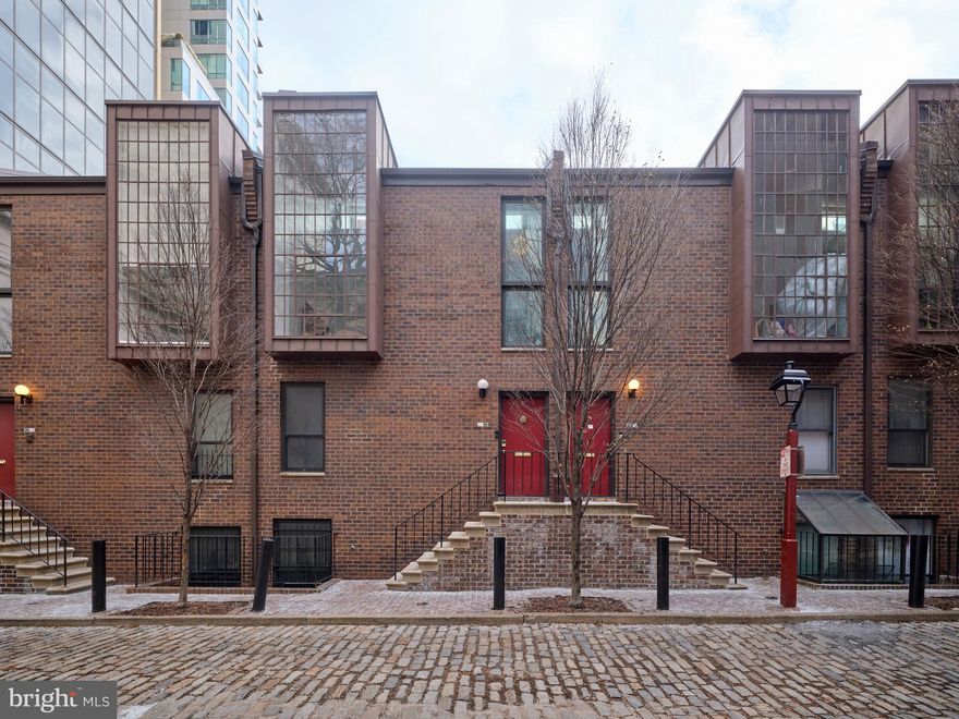 Welcome to 18 Saint James Court, a thoughtfully renovated 2-bedroom, 2-bathroom townhome tucked away on a quiet, charming block in the heart of Society Hill. Just steps from Washington West Park, this home offers a rare blend of privacy, architectural interest, and prime Center City living.

Upon entry, a generously sized coat closet provides practical storage before the home opens dramatically into the main living level. Soaring ceilings and an iconic two-story window flood the space with natural light, creating an airy, gallery-like atmosphere. Newly installed hardwood floors, updated woodwork, and custom drapery with automated window shades elevate the space throughout.

The chef’s kitchen is both refined and functional, featuring quartzite countertops, custom cabinetry with new hardware, a Wolf range and vent hood, Sub-Zero refrigerator, and Bosch dishwasher—ideal for both everyday living and entertaining. A spacious bedroom and a beautifully updated hall bathroom complete this level, which also includes a conveniently located washer and dryer.

A grand staircase leads to the upper level, where a stylish landing—currently configured with a bar area—overlooks the living space below. The layout was thoughtfully reimagined to expand the primary bathroom, enhancing both comfort and functionality.

The primary suite serves as a private retreat, featuring a large, built-out walk-in closet and a spa-inspired bathroom with a soaking tub, glass-enclosed stall shower, illuminated mirrors with integrated LED lighting and Bluetooth speakers, and Japanese bidet toilets. A striking glass ceiling allows natural light to pour in from the transom windows above the great room—an architectural detail that brings warmth and openness while maintaining privacy.

Additional upgrades include a sleek glass railing on the second floor, new door hardware throughout, and carefully curated finishes that reflect quality craftsmanship and intentional design.

Ideally located just minutes from dining, shopping, cultural attractions, public transportation, and major highways, 18 Saint James Court offers refined urban living in one of Philadelphia’s most coveted neighborhoods.

HOA Covers- Heater, A/C, Roof, Windows, Exterior, Common area maintenance