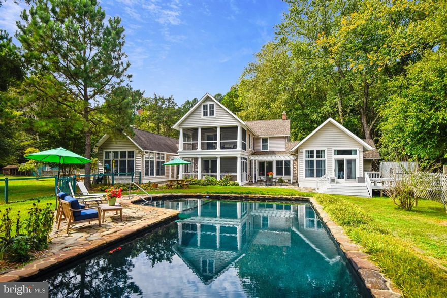 The Ultimate Private Waterfront Retreat! This stunning almost 14 acre property provides waterfront living in a serene country setting, with luxurious amenities and its own pier for life on the water.  An easy trip from the metro area, this 5 bedroom/3.5 bath 5,300 sq. ft. home has been beautifully expanded and updated with gorgeous finishes and expansive windows. Every detail has been thoughtfully designed, from the slate floors to the vaulted ceilings and everything in between. The spectacular Kitchen features Viking appliances, white cabinetry, quartz countertops & an island with plenty of seating and a fabulous light fixture. The Kitchen is open to the Family Room, complete with an oversized stone wood-burning fireplace and walls of windows overlooking Carrs Creek. The main level Primary Suite boasts an elegant attached bath with a glass enclosed slate shower, separate jetted tub, large walk-in closet & sliding doors to the deck & hot tub. There is also a spacious Office and another Bedroom on this level, perfect for guests. Upstairs, there are 3 more Bedrooms - one en-suite with its own private screened porch with amazing views! There are so many perfect spots to relax here - on the charming main level screened porch, or the lovely stone patio, around the fire pit, in the hot tub or cool off in the pool. There is a separate fenced area with a chicken coop, gardening shed, vegetable garden & room for your chickens to roam - fresh eggs and veggies are a true delight! Sit on your own private pier with an additional floating dock to launch paddle boards & kayaks & don’t forget to practice your golf game from the Tee Box.  A large detached garage with bathroom & second level  is perfect for the car enthusiast or hobbyist.  The property is completed with a commercial whole house generator; you’ll never have to worry about the next power outage. Close to the restaurants & marinas of Galesville, Deale & North Beach this stunning property is also convenient to DC, VA, Joint  Andrews  AFB & Annapolis.