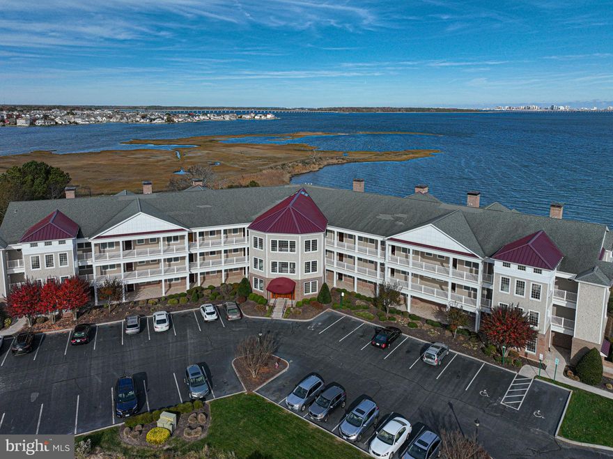 It is all about the view from this luxury Bay Front 3 bedroom, 2 bath one level Condo in the prestigious Points Reach Community in Ocean Pines, Md. Located on the top floor, the views are spectacular. The home boasts hardwood floor, gas fireplace and grill, granite countertops, plantation shutters, 11-foot ceilings, crown moldings to name a few. The kitchen and baths were redone in 2018 and are stunning. The open floor plan lends itself to easy living and entertaining. The master suite has sliding door to the private balcony overlooking the water. This home's balcony is half covered and half open, you can enjoy both the sun and the shade. The master bath has been redone and is luxurious.  There are two other bedrooms, one is set up as a guest room and the other is currently being used as a workout space. The building has a climate-controlled foyer and an elevator. An additional storage space is available to all owners in the “Bike Barn”. The condo fees include flood insurance, biannual checks of geothermal systems and gas grill, water, trash, and landscaping of common areas. Homeowner if offering a 1-year home warranty. Schedule a showing to see the lovely home.