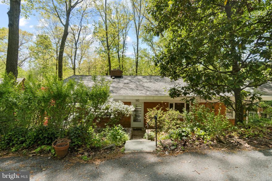 Surround yourself with nature in this brick rambler on a quiet street in Takoma Park. Features a large living room with floor to ceiling windows, fireplace, hardwood floors, and exposed ceiling beams.  3 bedrooms and 2 bathrooms on main level, including spacious primary bedroom with en suite bathroom. Basement in-law suite with kitchen has rental potential. Great location! One block to Sligo Creek Trail, two blocks to the bus stop on Flower and 1.3 miles to Takoma Metro Station. Must see in person to appreciate panoramic views of Sligo Creek. Home is in need of some updates to make it your own, selling as is. 
LOCATION: The entrance to the home is located at 8005 Edinburgh Lane, use that address for GPS directions rather than Sligo Creek.
Offers due Wednesday 5/11 at 3pm