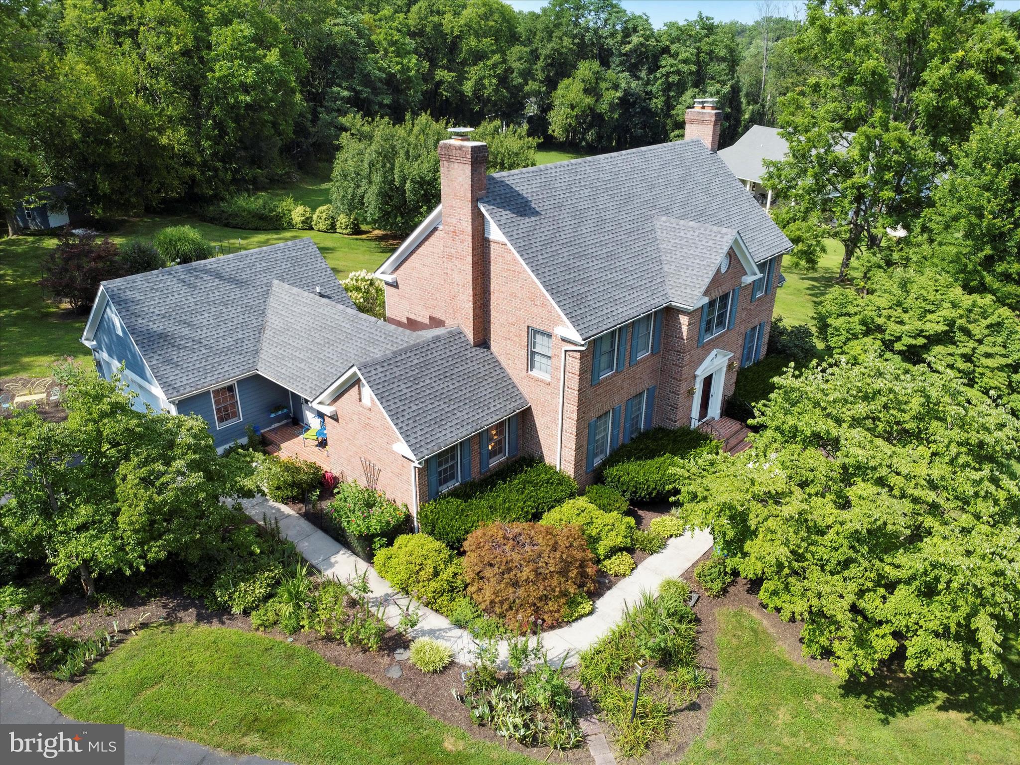 This stunning mostly all brick Colonial offers over 4,000 finished square feet of living space. Nestled on 1.41 acres and backing to trees for added privacy, located in a quiet cul-de-sac, the home boasts extensive landscaping, a paved driveway, and a 2-car garage. Relax or entertain on the large back deck, perfect for gatherings with friends and family. Inside, you'll find 4 generously sized bedrooms, 3 full baths, and 1 half bath. The expansive eat-in kitchen features beautiful built-in cabinetry and flows seamlessly into a formal dining room—ideal for hosting. The main level offers two dedicated office spaces with built-in cabinetry, a large mudroom off the covered side porch, and multiple living areas with timeless colonial charm. An additional shed in the backyard provides convenient storage. This well-maintained home features numerous recent updates, including a roof replacement and air purifier installation in 2019, a new hot water heater in 2023, and both a new sewage pump and sump pump installed in June 2023. A new washing machine was added in April 2023, and the basement received new carpet and padding in 2019. This home combines space, comfort, and functionality in a peaceful, sought-after location—don’t miss the opportunity to make it yours!