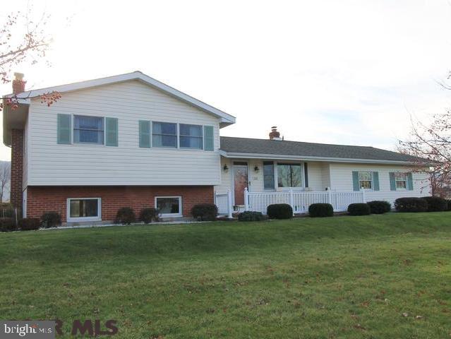 This immaculate multi-level home sits on 2.20 acres, surrounded by fields and beautiful mountain views. The eat-in kitchen is spacious and bright while beautiful hardwood floors span throughout the hallways, bedrooms and living room. The finished lower level has a cozy wood/coal fireplace with access to the attached greenhouse. Additional storage space and a laundry room are located in the basement. The back patio is perfect for entertaining, overlooking the huge lot with plenty of yard space, privacy trees and mountain views. If this isn't enough, a large workshop and storage area is located right off of the garage for easy access. Back of property could be used for additional building lot if approved by township zoning. Don't miss this great home with so much to offer!