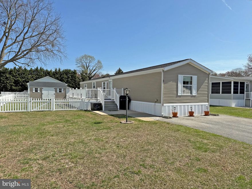 Nice three-bedroom, two-bath home is just 3 miles to the Rehoboth boardwalk and beaches! Silver View Farm is close to shopping & restaurants, too. And the DART Bus Park-n-Ride is just down the road if you don’t feel like hunting for parking at the beach. This home features vaulted ceilings for a more spacious feel to the interior. Popular split bedroom plan. The living room opens to the eat-in kitchen.  The kitchen has a breakfast bar and space for a dinette set. Appliances include an electric range, range hood, dishwasher, disposal, countertop microwave, and a fridge with a water/ice dispenser. The main bedroom, which is en Suite, is at the rear of the home. It has a walk-in closet, and its private bath has a tub/shower. The other two bedroom share the second full bath in the hall, which also has a tub/shower. The laundry room has a front-load washer and dryer set, and storage shelves that make a great pantry area. Spacious side deck with low-maintenance composite boards. Fenced yard (fences are no longer allowed, so this is a “legacy fence”). Oversized shed. Annually renewable leasehold interest: Lot Rent of $723.00/mt. includes water & trash/recycle service (Lease renews annually on Jan. 1 with any increase capped per law – 25 Del. C. Sec. 7050-7054). Homeowner pays electric, sewer, cable/Internet (Xfinity) & lawn service. Silver View Farm allows 2 pets. Pool membership is optional (approx. $175/person with discounted group packages). A Park Application ($72/person) is required for all adults who will occupy the home for 14 or more consecutive days. Buyers are accepted as a Resident in Silver View Farm based on the following criteria: 1.)income verification, 2.)high credit bureau score, 3.)evaluation of debt-to-income ratio, and 4.)criminal background check. Note: Rentals are NOT permitted in this community - but friends & family are welcome to visit you. Financing may be available to qualified borrowers from only a very few Lenders that specialize in installment/chattel loans for manufactured homes on leased land. Closing costs will include a 3.75% “real estate transfer tax” (DMV Doc Fee) & a Settlement Agent Fee.