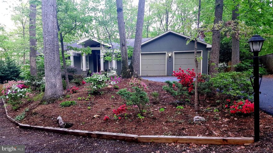 Welcome to this stunning Craftsman-style home set on a private, wooded lot in the heart of Alexandria. Nestled on half an acre and backing to 50 acres of protected parkland, this spacious two-level retreat offers over 4,200 finished sq ft, 4 bedrooms, and 4 full bathrooms—all thoughtfully designed with striking architectural character throughout. From the moment you turn onto Upland Drive from Elmwood and make your way up the tree-lined street, it feels like you're entering a secluded retreat and leaving the chaos of the outside world behind. The previous owners lovingly referred to this home as “our tree house.” Step inside to a wide, welcoming foyer with soaring 9-foot ceilings that immediately set the tone for the open, airy feel of the home. The formal dining room is an elegant space featuring crown molding, wainscoting, recessed lighting, and a statement chandelier. The formal living room boasts top-down bottom-up blinds and a gorgeous custom accent wall. The expansive family room is a true showstopper, with a cozy fireplace, stunning custom built-in bookcases, crown molding, and recessed lighting. Just off this space, a door leads to a screened-in porch—described by the owners as their personal sanctuary—flanked by two additional decks. The tranquil wooded views offer a sense of calm that’s hard to find elsewhere. The kitchen offers a bright and functional space, featuring a skylight, recessed lighting, white cabinetry, tiled backsplash, and updated stainless steel appliances. There's plenty of room to add an island or a casual dining table for breakfast. A large pantry provides ample storage, and there's direct walk-out access to the screened-in porch which includes a lighted ceiling fan and offers stunning, tranquil views of the surrounding woods, fully fenced backyard,  river rock landscaping and a stacked stone fire pit. The upper level features a spacious primary bedroom with a ceiling fan, crown molding, recessed lighting, and a built-in closet with decorative doors. Enjoy walkout access to the deck and a fully remodeled en suite bathroom, complete with updated lighting, flooring, designer tile in the shower, and a separate large soaking tub. Wow! The dual-sink vanity boasts elegant marble countertops, making this space truly stunning. The additional two bedrooms on the upper level are generously sized with carpeting and overhead lighting. The hall bath includes a shower-tub combo. The lower level offers a large, open space with built-in shelving and a wood-burning stove, providing a versatile area ideal for entertaining, a kids’ playroom, etc. There’s also a bonus room, a sizable unfinished storage area, an additional bedroom, and two full bathrooms, all featuring recessed lighting. A separate laundry room includes a full-size washer and dryer, as well as a built-in dog shower. An access door leads to the backyard, adding convenience to this spacious lower level. The home also features a spacious oversized two-car garage featuring built-in storage and attic access. Recent updates totaling over $60,000 include a newly renovated front exterior entry, along with new stainless steel appliances and updated hardwood and carpet throughout the home. The back deck was re-screened, and the cabinet faces have been replaced. The home has been freshly painted and is move in ready! HVAC system was replaced w/in the past 5 years, and the hot water heater was updated in 2020. While the roof and windows are pre-2015. The house feeds to Clermont Elementary, Twain Middle, and Edison High School. Enjoy a prime location that offers easy access to picturesque walking/jogging trails. Just minutes away shopping/dining in Old Town Alexandria, Kingstowne, and Springfield Town Center. Swift access to 395/95/495 & 3 nearby Metro stations: Springfield, Van Dorn, and Huntington. 10 minutes to Reagan Airport/Pentagon/DC. Showstopper! Make your appointment today! (Some pics virtually staged.)