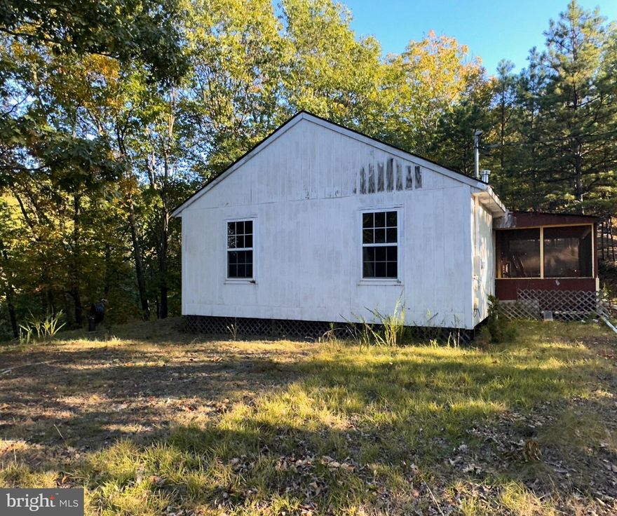 Cabin in a remote country setting on 5.37 acres.  Cabin needs some finishing work, but can be fixed the way you want it.  Nice view potential on both sides. 200 amp service, well, and septic in place.  A nice remote get away.  Frontier Fiber Optic has been working in the this area to presumably be bringing in new internet options.