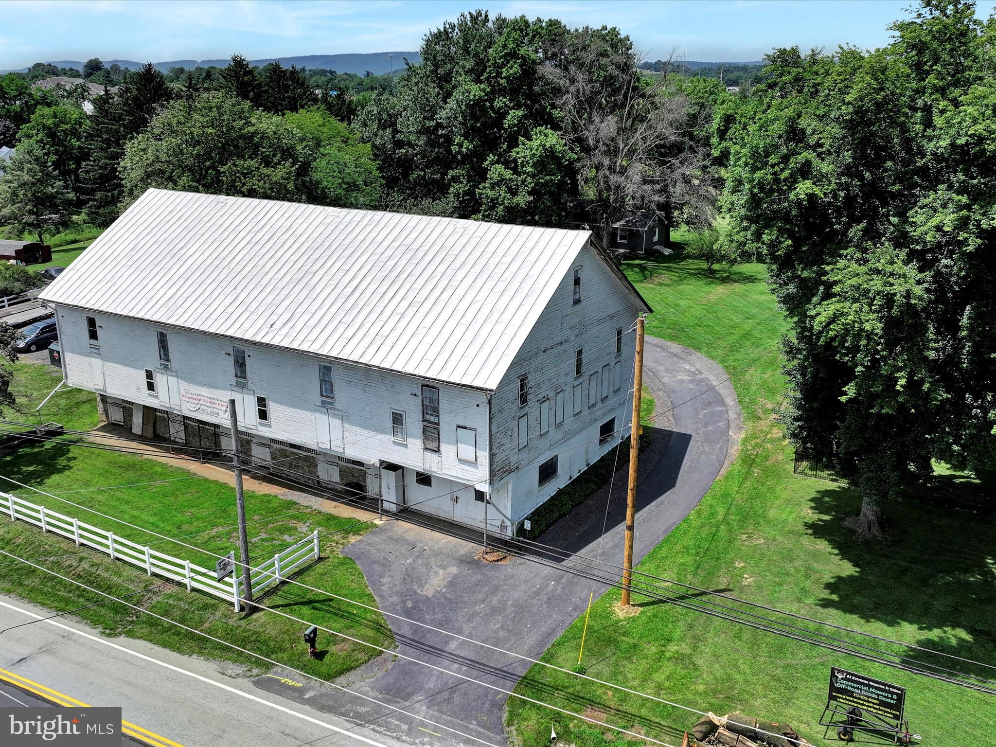 Unique Mixed-Use Opportunity on 8.5 Scenic Acres – Live, Work & Thrive!
Fantastic opportunity to run your business from home with this one-of-a-kind mixed-use property nestled on 8.5 acres of beautiful countryside—yet conveniently located near major highways Rte 81, Rte 22, and Rte 39 for easy access and visibility. Cattle fencing is already in place surrounding most of the property for those interested in raising livestock.
At the forefront of the property is a massive, 3-story converted bank barn offering over 16,500 sq ft of versatile space—ideal for a wide range of business ventures. Currently outfitted as a small engine repair and sales shop, the barn’s main floor features:
New fire-retardant walls & insulation
Central air & surround sound system
Modern windows, air lines throughout & updated electrical
Oversized two-story garage door & showroom area
Kitchenette for employees
Rough-in plumbing for potential bath
Security system with full camera coverage
Natural gas furnace (1,000 BTU) + Wi-Fi thermostat
220V compressor & back-up generator included
Each workshop bay has its own dedicated circuit, and the second floor—accessed via a full staircase—is a large open area ideal for storage, expansion, or creative studio space. The top-floor loft retains a charming historic crane used for haybales, while the lower level has been structurally reinforced with new beams.
Step outside and enjoy a picturesque pond, ample parking, and open green space—perfect for equipment, outdoor work, or relaxation.
At the end of the drive sits a charming 3-bed, 2-bath ranch home, offering:
Warm knotty pine walls & wood-burning fireplace
Updated LVP flooring & remodeled bathrooms
Partially finished basement with 2nd kitchen, bath & private entrance – perfect for in-law suite or rental income
Updated electrical, owned solar panels, new well pump, and reverse osmosis system
Attached garage with 30,000 BTU gas line for heat and an on-demand hot water.
Whether you're an entrepreneur, craftsman, farmer, hobbyist, or investor, this property delivers incredible potential for home-based business operations, rental income, and peaceful living—all in one.