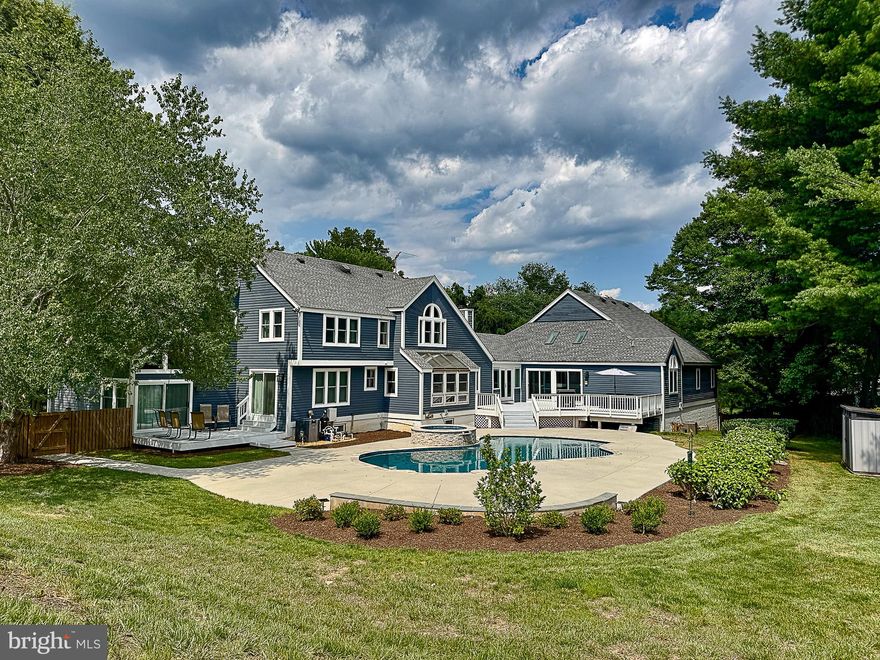 Over 1.8 acres in coveted Vienna and with no HOA, this custom contemporary home offers a blend of luxury and functionality.   Located on a no-through street with just a few homes.  Fitness enthusiasts will appreciate the custom two story indoor 39 x 42 basketball/sport court and separate gyms.  Enjoy the newly resurfaced heated pool and spa,  Pebbletec finish, two decks, perfect for summer gatherings. 
The heart of this home is the gourmet renovated kitchen  featuring Kitchen Aid appliances, quartz countertops, and modern bamboo custom cabinetry that highlights its sleek, contemporary design. Adjacent is a family room with a vaulted ceiling and a stunning stone fireplace.  Main-level study could be used as a bedroom.  Custom features throughout including hardwood floors, exposed beams, vaulted and cathedral ceilings.

The primary bedroom includes a sitting room, cathedral ceiling with exposed beams, updated luxury bath with a soaking tub, and seamless glass shower, dual vanities, large walk-in closet.  Finished lower level with media area, den (used as bedroom), full bath and rec room.

Experience modern living at its finest in this exquisite Vienna residence.  Great location 1.5 miles from the W&OD, nearby access to a number of greenway trails and streams.  The trail network connects to the CCT.  4 miles from the Vienna Metro/Orange line, just 9 miles to Dulles International Airport.  Close proximity between downtown Vienna and Reston Town Center.  Numerous updates include roof (2017), Pool updates (2025) $105,000, New windows just installed ($83,000), primary bath remodel (2020), Upstairs baths (2022), new driveway and masonry/stone walls (2023).  Over $650,000 in improvements in the past 10 years.