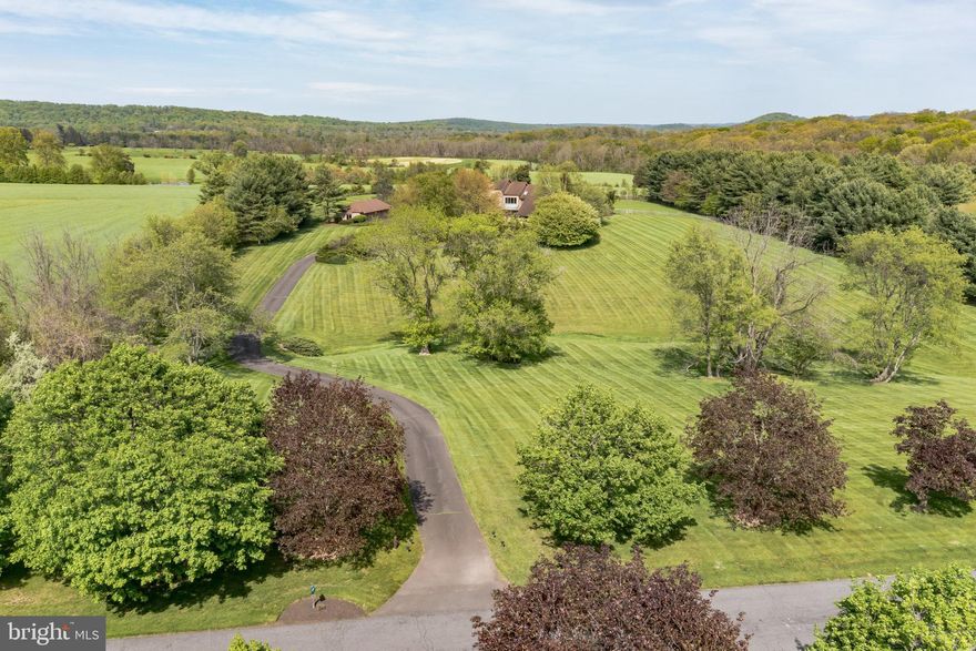 Magnificent 6.5-acre pastural estate nestled deep in the rolling hills and woodlands of Bucks County. This property offers a rare opportunity for those who seek tranquility with nearby modern conveniences. This estate offers breathtaking views of nature’s beauty along with manicured grounds and incredible perennial gardens.  The Estate is backed by preserved farmland  All rear walls of the current  home have open views of the property’s rear decks, patio, pool, meadows as well as the hills and valleys of New Hope. There is also  custom designed pool and pool house with expansive multi-layer deck and patio. The estate also includes a large four-vehicle detached garage with 4 remote doors  and multiple skylights.    The possibilities are endless.  Current homes has 4 zone heating and cooling, oil hot water and heat system with 2 heat pumps for backup, and 400-amp electric service.   This secluded property is within minutes of Newtown, Doylestown, New Hope, and Flemington and easy access to major highways.   This is the idyllic lifestyle most can only dream of, so come for a tour and experience a taste of your new beginning!