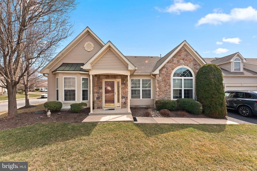 Welcome to this stunning, move-in-ready gem nestled within the highly sought-after Villas at Shadybrook community, offering over 2,200 square feet of meticulously designed living space. As one of the largest and most desirable models in the neighborhood, this exceptional 3-bedroom, 2.5-bathroom home boasts a convenient main-level primary suite and pristine hardwood floors that span most of the first floor. The open-concept design of this home effortlessly blends comfort and elegance, making it an entertainer’s dream.
The spacious living room, with its dramatic vaulted ceilings, seamlessly flows into the formal dining area, creating an expansive, inviting space perfect for hosting gatherings or relaxing in style. Just beyond the dining area, you’ll find the heart of the home—the chef-inspired kitchen. Adorned with timeless cream cabinetry, exquisite granite countertops, and a stylish breakfast bar, this kitchen is as functional as it is beautiful. It opens into the great room, which features soaring cathedral ceilings, recessed lighting, and a striking gas stone fireplace framed by Palladian windows, creating a warm and welcoming atmosphere.
Adjacent to the great room, a bright and airy sitting room, bathed in natural light, offers an ideal space for quiet relaxation, reading, or working from home. The first-floor primary suite is a tranquil sanctuary, complete with a Palladian window, a generously sized walk-in closet, an additional closet, and a spa-like en-suite bath featuring a large soaking tub, a separate shower, and dual vanity sinks. A versatile second bedroom on the main floor offers ample closet space, with a conveniently located full bathroom nearby.
The thoughtfully designed first-floor laundry room, equipped with custom cabinetry for additional storage, leads directly into the attached two-car garage. With an abundance of storage options throughout, including numerous closets and custom cabinetry, this home ensures everything has its place.
Upstairs, the finished loft area offers a spacious third bedroom suite with generous closet space, additional storage, and a well-appointed half bathroom.
Located in the charming and historic Bucks County, Pennsylvania, The Villas at Shadybrook is an exclusive 55+ active adult community brimming with luxurious amenities and activities. The private clubhouse is a true highlight, offering state-of-the-art facilities, including both indoor and outdoor pools, a fully equipped gym with locker rooms, a library, and a grand ballroom. The community is just minutes from major shopping destinations, including the brand-new Wegmans grocery store, as well as easy access to Interstate 95 and other major highways, making trips to Philadelphia, Atlantic City, and New York City a breeze.
At The Villas at Shadybrook, you’ll experience the perfect combination of upscale living, convenience, and a vibrant, active lifestyle. This is more than just a home; it’s a lifestyle waiting to be embraced!