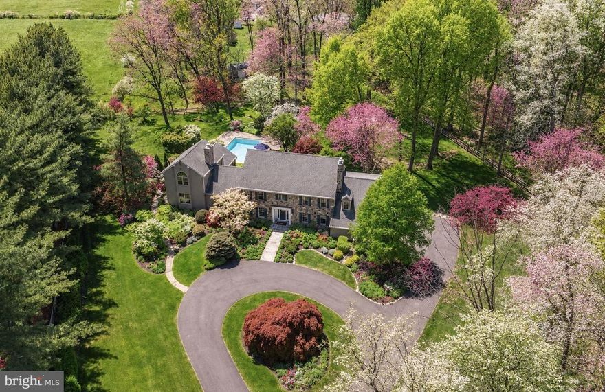 Offering an exclusive lifestyle set amidst meticulously curated grounds and sweeping greenery, this exceptional residence introduces a unique chance to immerse oneself in the sophistication of Bucks County living, in one of the most sought-after locales. Situated within the highly esteemed New Hope-Solebury School District and just a stone's throw away from the quaint river towns of New Hope, Lambertville, and Stockton, 3521 Sugan offers easy access to renowned eateries, exclusive shopping, art galleries, and everyday conveniences while preserving a remarkable level of seclusion and tranquility. The estate has been thoughtfully conceptualized for both social gatherings and relaxed day-to-day living, offering a range of outdoor spaces such as multiple patios, a generous rear deck, a resort-style pool, a custom koi pond with water features, and a built-in barbecue area, all nestled amidst mature flora and picturesque natural beauty. The moment you enter the property, a sense of private, inviting, and effortless elegance is experienced. The interior of the home is graced with hardwood flooring that spans the main level, where comfortable gathering spaces offer a harmonious blend of warmth and sophistication. The front foyer extends into a formal dining room and a cozy piano room with a wood-burning fireplace, crafting an impeccable setting for intimate soirees or entertaining guests. The living room, which serves as the heart of the home, provides a warm ambiance with a stone-accented wood-burning fireplace, custom bar, window seat, and double French doors that meld seamlessly with the outdoor areas. The kitchen is equally impressive, with a large center island and furnished with double Wolf ovens, including a convection oven, while the attached sunroom beautifully bridges the interior with the picturesque exterior and poolside terraces. The property's layout has been crafted with exceptional flexibility, featuring a first floor, newly built, secluded in-law suite nestled within its own wing, equipped with a sitting room, walk-in closet, and full bath with walk-in shower. Nearby, a functional mudroom w/custom built-ins, laundry room, and pool-access bath ease the transition from outdoor festivities back indoors. The west wing houses an expansive executive office with extensive built-ins and a bright atrium that floods the space with natural light. A secondary staircase leads to an additional en suite bedroom, perfect for guests or extended family stays. On the upper level, the primary suite offers a luxurious haven complete with a fireside sitting room, newly renovated oversized walk-in closet, dormer window seats, and a brand new luxurious bath featuring dual vanities, radiant heat flooring and a walk-in shower. Three additional bedrooms with spacious double closets and a well-appointed hall bath complete the upper level. Carefully preserved,  thoughtfully enhanced and offering pastoral horse farm views, this extraordinary estate embodies the essence of Bucks County living, striking a flawless balance between elegance, comfort, privacy, and proximity to the region’s most cherished destinations.