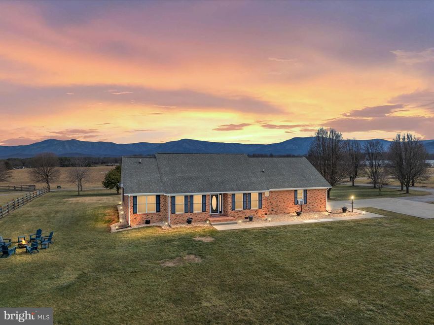 This stunning custom all-brick ranch is situated on 1.75 acres, offering breathtaking mountain views in every direction. Fully renovated and sold completely furnished, this home has been successfully used as a vacation rental with excellent income potential. With no HOA or covenants, it features a 4-bedroom conventional septic system and is conveniently located on a dead-end road with road frontage.
Spanning 2,035 sq. ft., the home includes 4 bedrooms, 2.5 baths, a formal living room with a gas fireplace and skylights, a formal dining room, a den/office, and a kitchen with a cozy breakfast nook. Additional features include a laundry room with a sink and shelving, an oversized side-loading garage with a spacious utility room, and pull-down attic stairs for extra storage. Multiple rooms provide access to an expansive deck 21x27, perfect for enjoying the serene surroundings.

Located just minutes from Luray Caverns, Lake Arrowhead, Massanutten Resort, and Shenandoah National Park, this property offers the best of both tranquility and convenience. The sale is subject to county approval for property division.