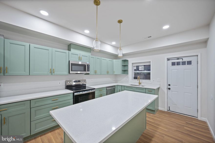 A stunning remodel has taken place behind the door of this brick 4BR/3.5BA Townhome located in the quiet community of Biddle.  Make your way to the front door and step inside a home filled with natural light, high ceilings, an open concept main floor, recessed lighting, and luxury flooring.  The main living area offers a spacious living room boasting an electric fireplace feature, a dining area, a half bath, and a stunning kitchen. The kitchen is "mint" , literally a stunning presentation when you walk through the front door. The kitchen boasts mixed metals with gold and stainless accents throughout, plenty of cabinets including a pantry cabinet and open shelving, stainless steel appliances, sleek quartz countertops, a deep sink under a window, and an island with breakfast seating and pendant lights.  On the second floor are two sizable secondary bedrooms, a full bath with a walk-in shower, and a spacious primary bedroom with a walk-in closet and a private en-suite featuring a walk-in shower. The lower level is finished offering additional living space featuring the fourth bedroom, a full bath with a walk-in shower, laundry, storage, and a large family room for everyone to enjoy.  From the kitchen step outside to newly constructed stairs leading to a large fenced patio with room for entertaining family and friends.  This home is move-in ready with so much to offer new homeowners and is located nearby shopping, restaurants, and commuter routes, a unique city experience!!