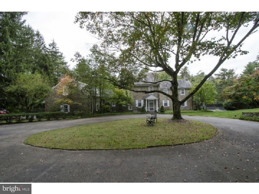 Charm meets incomparable setting in this 56 year old four bedroom stone colonial home set on 5.43 acres with swimming pool and tennis court in Gladwyne. Most welcoming arrival courtyard leads to a bright center foyer offering views of the expansive rear yard and resort quality amenities.  To the right of foyer, a large Living Room with fireplace extends to a private office with French doors, opening to a deep blue stone terrace. The terrace extends the length of the home with entry to the LR, foyer and dining room, making its area an ideal transition space for indoor/outdoor entertaining. The formal Dining Room with exquisite millwork is highlighted by an intimate offset smaller dining space with three walls of windows. The Dining room proper connects to the renovated kitchen featuring honey toned wood cabinetry, granite counters and chefs level appliances. Rich hardwood floors cover both the first and second levels adding to the charm and continuity of the home.  A beautifully turned formal staircase leads to a large Master Bedroom with adjacent sitting room and en-suite bath.  Additional elegant bedroom with corner fireplace, generous closet and private bath.  A second level gathering/family room provides access to the homes 2 remaining bedrooms and shared bath creating an ideal space for television, computer or comfortable upstairs library.  Partially finished lower level currently purposes as a recreation room and gym offer additional informal space.