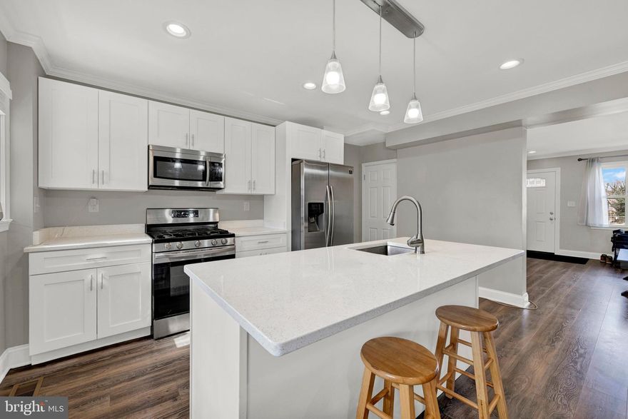 WELCOME! Renovated in 2020, this well-maintained home offers over 1,800 sq ft of living space, with the open main level bathed in natural light. Hardwood floors and a bright kitchen featuring quartz countertops, a large island, pendant lighting, and stainless-steel appliances complete the space. Upper level includes spacious bedrooms and an updated full bath. Finished lower level provides extra living space and bonus room or potential bedroom that also has a full bath! Enjoy a covered front porch or covered rear deck, and a great yard for entertaining. Two car private parking pad option – LARGE BACK LOT!

NO HOA! This Home Qualifies For 100% Financing & $10,000 In Closing Cost Assistance -. Convenient to Chinquapin Park,  shopping at Belvedere Square, short commute to Towson University, Morgan State University, Loyola University  and major routes (83 & 695).