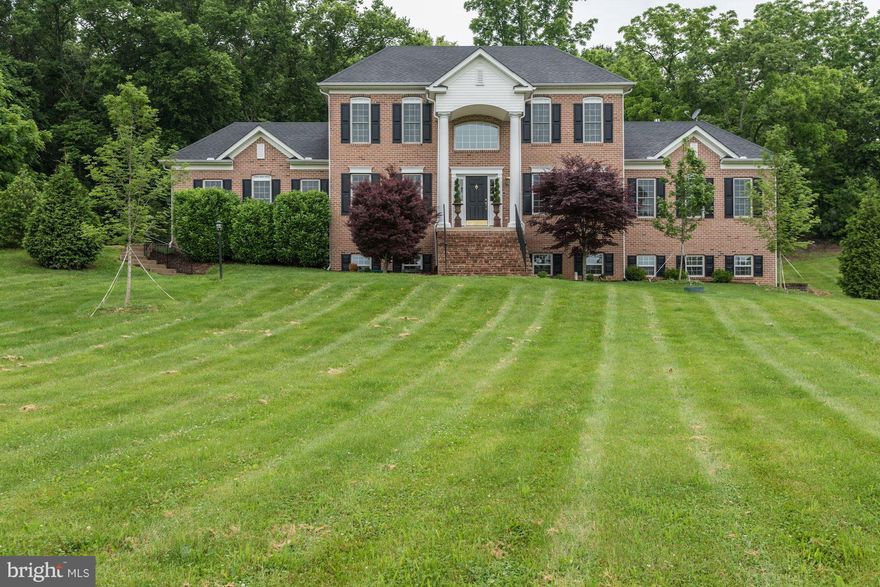 Gorgeous Custom Built Brick Colonial on 4+ acres. HW throughout main level, freshly painted neutral interior, gourmet kitchen w/granite, tile, & SS appliances. Main level master suite w/ 3 sided fireplace, sitting room, and expansive Master Closet area. 3 UL BR incl a princess suite, UL Laundry Room. LL w/BR, rec area, second laundry and fully functional safe room! Mnt views, large rear patio area