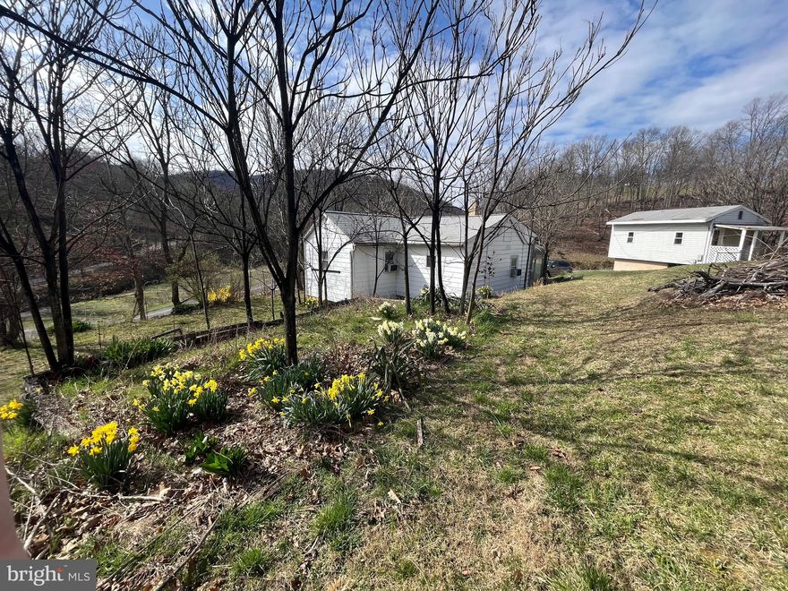 GREAT UNRESTRICTED PROPERTY LOCATED LESS THAN 10 MILES FROM CUMBERLAND MD. 2 BED 1 BATH WITH AN OUTSIDE BASEMENT ENTRANCE (NICE WORK AREA/STORAGE) HAS AN OUTBUILDING WITH MANY POSSIBILITIES. THE HOUSE AND OUTBUILDING HAVE ALL NEW FLOORING. HOUSE HAS NEW PAINT INSIDE AND OUT. BEAUTIFUL SETTING ON 2.12 ACRES.