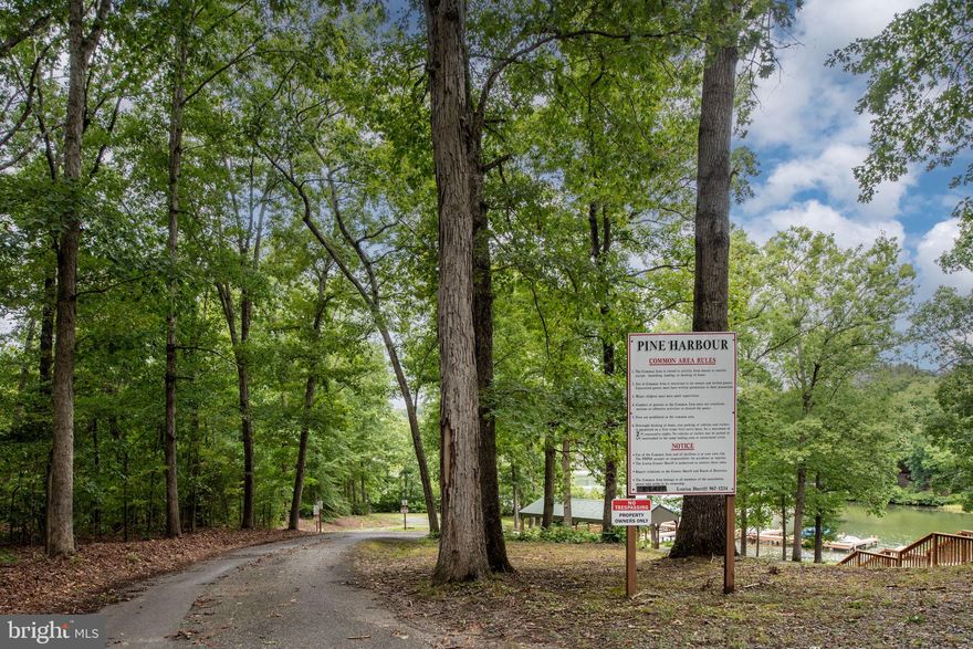 Fantastic lake access  Lot located on  Lake Anna's public side! This vacant lot in the gated, family-friendly Pine Harbour community is primed and ready for your dream home. The groundwork has already been laid - quite literally! The site is cleared, the driveway is in place, and the well is drilled. Plus, the alternative septic system has been designed specifically for this lot and the seller has paid the design fees, saving you time, money and headaches.
Imagine lazy summer days spent at the community's expansive picnic area, complete with a charming gazebo. Launch your boat from the private ramp or secure a yearly boat slip for easy lake access. And for those impromptu fishing trips, there are first-come, first-serve slips available too!
Golf cart enthusiasts, rejoice! This community is perfectly suited for zipping around on your favorite four-wheeler, golf cart or just a morning or afternoon walk. It's like a perpetual vacation where the fun never stops!
Talk about location, you're just a short drive away from groceries, mouthwatering restaurants, and even a veterinary hospital for your furry friends. And for the craft beer aficionados, local breweries are within easy reach. It's the perfect blend of peaceful lake living with convenient amenities at your fingertips.
So, whether you're looking to build your forever home or a weekend retreat, this lot offers the ideal canvas. With Lake Anna as your backyard and a welcoming community at your doorstep, you'll be living a good life in no time. Don't let this opportunity float away - make a splash and claim your piece of Lake Anna today.