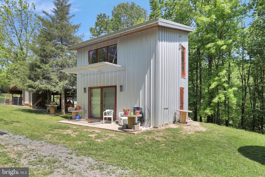 Dream big on these 4.65 UNRESTRICTED acres.  This modern design property features stained concrete floors on mail level and beautiful heart of pine flooring on the upper level.  The unique Passive Solar design shades the home in the summer and produces warmth in the winter.  With additional foam insulation, 2x8 wall construction, modern cabinets, custom milled beamed ceiling downstairs and wood ceilings upstairs, this home was built with quality in mind . Top end products and LED lighting grace the home throughout.  A beautifully crafted Murphy Bed adds additional sleeping options for your guests, but conveniently stores away.  A large one car finished garage has a wood stove and A/C, perfect for a home office.  Enjoy the additional outdoor building for storage or an animal shelter.  Bring your kayaks and fishing rods as the Opequon runs through the property. Plans for phase 2 , which will convey, could add an additional  1200 sq feet.  These plans were crafted by a local architect. Pipes in the floor have been run to add thermal heating in phase 2 of construction. Bring your hobbies and take advantage of this wonderful opportunity!