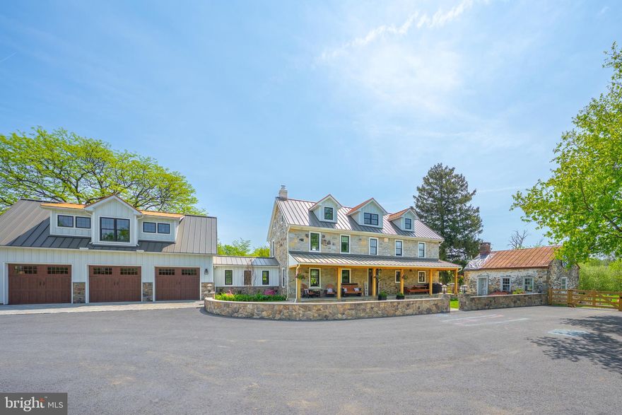This fully renovated farmhouse on over 19 acres in Berks County is truly a once in a lifetime opportunity!  Welcome to 307 Schaeffer Road, a homesteader’s ultimate dream with 4 bedrooms, and 4 full bathrooms! This beautiful home was fully renovated in 2023 with all the modern amenities for easy living.  As you approach, the home’s curb appeal warmly invites you in. The oversized front porch with a cedar ceiling has room for multiple seating areas to enjoy the breathtaking view of the property.  Enter into the grand foyer with herringbone brick flooring with a custom compass inlay.  To the right is a chef’s dream kitchen with a 36 inch Wolf dual fuel range, 24 inch Cove dishwasher, Sharp under counter microwave, gas fireplace, and a copper farmhouse sink.   All cabinetry was made locally, and the range hood was made from the attic floorboards that are 150 years old.  The kitchen opens into the massive dining room with original beams flanking the ceiling.  The living room is a moment of its own, with the original refurbished fireplace and a beautiful new mantle as the focal point. Through the arched stone entryway, you enter the spacious mudroom.  Custom cabinetry lockers are on one side, while the washer and dryer flank the other side. The room is completed with a full bathroom.  On the second floor there are three large bedrooms, and two remodeled full bathrooms. The third floor is an all-new primary suite. The custom stone wall is a showstopper, and the window bench, cabinets, and vanity doors are all made from the original attic floorboards as well.  Enter into the bathroom on radiant heated tile floors to a frameless glass shower with multiple heads, a large walk-in closet, and a second washer and dryer.  The house is energy efficient, with all new windows, exterior doors, and a metal roof.  Mini split heat and air conditioning units were installed in every room in 2023.   The new three car heated garage has a cobblestone apron, 8 foot tall garage doors, a 240V outlet installed for electric vehicle charging, and MyQ garage door openings.  Going upstairs from the garage is a massive work out gym that will blow you away, complete with rubber flooring.  This gigantic space could also become a 5th bedroom.  The exterior property has two miles of fencing along the perimeter, with four board fencing around the pasture and residence. It is serviced by separate well water, with three exterior spigots by outer fields, and irrigation in the back field, used to grow trees.  In 2021, a 24 x 36 pole building was built, as well as 19.5kW solar panels ground mounted in the rear.  Just when you think the home can’t get any better, there’s a whole house generator and a new gas line!   Do not miss this extremely rare opportunity to own a generational property!