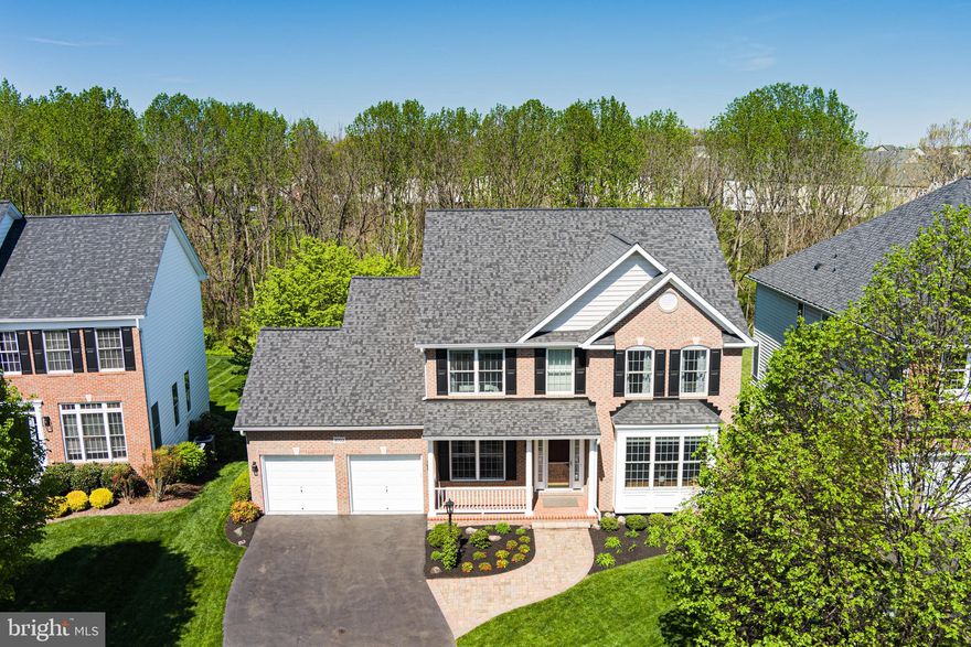 Welcome to your dream home in the Urbana Highlands!  Discover this beautifully maintained, one-owner home nestled on a premium lot backing to open green space and mature trees in the highly sought-after Urbana Highlands community. This exceptional property combines elegant living with natural beauty, offering the perfect setting for relaxation, entertaining, and everyday life.  As you step through the front door, you'll immediately notice the gleaming, just-refinished hardwood floors. To the left of the foyer, a dedicated home office provides a quiet space for remote work or study. To the right, the bright and inviting living room opens seamlessly into the formal dining room—perfect for hosting dinner parties and family gatherings. Continue through the entryway to the heart of the home: a beautiful kitchen and family room area. The kitchen is a chef’s dream with granite countertops, a central island, stainless steel appliances, abundant cabinet and counter space, and a large pantry. Sliding glass doors lead to a beautiful oversized composite deck with steps down to a lower patio—ideal for enjoying morning coffee or dining al fresco while overlooking the tranquil green space.  The cozy family room features a gas fireplace, creating a warm and inviting atmosphere. Additional main-level highlights include a convenient laundry/mudroom just off the garage entry and a well-appointed half bath near the foyer.  Upstairs, retreat to your spacious primary suite complete with an oversized walk-in closet and a luxurious ensuite bath featuring dual vanities, a soaking tub, separate shower, and a private toilet room. Three additional generously sized bedrooms and a full hall bath complete the upper level. The walkout basement offers incredible flexibility with abundant natural light, a full bath, a fifth bedroom (currently used as a second office), and two finished spaces perfect for movie nights, a home gym, game room, or whatever suits your lifestyle. This home has been meticulously cared for and it truly shows in every detail. With timeless design, functional space, and unbeatable views, it’s ready for you to move right in!  Urbana offers top-rated schools, miles of scenic walking and biking trails, and proximity to major commuter routes, and nearby shopping and dining.