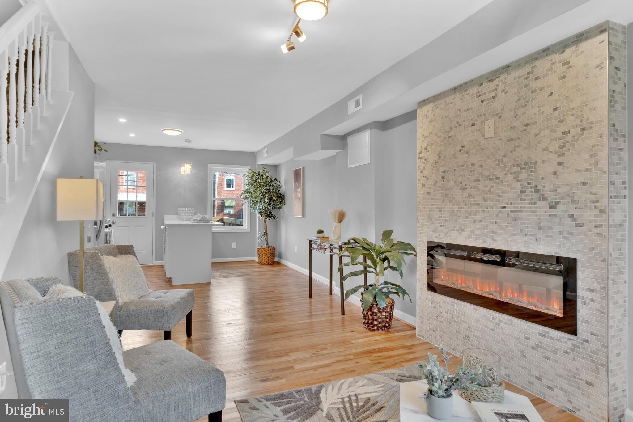 Refined luxury in Belair-Edison! This east Baltimore townhome has been meticulously renovated with care for your peace of mind. Imagine relaxing on your front porch & connecting with neighbors. Enter the front door to an open floor plan perfect for receiving guests. The electric fireplace adorned with floor to ceiling stone tile greets you with style & elevation. Hardwood floors lead you to the open dining area & peninsula kitchen with breakfast bar seating. The stainless appliances & quarts counters glisten under pendant lighting. Shaker style cabinetry & custom tile back splash finish this space. A rear deck extends the entertaining to the outdoors. Having a lower level primary offers quiet privacy from the rest of the home with new carpeting & private bath. The primary bath is finished in white ceramic tile flooring & tile shower. The lower primary makes immediately washing the stress of the day away as you come home with a direct entrance from your rear parking pad. Upstairs benefits from two spacious bedrooms & a center hall bathroom finished in ceramic tile & tub shower combination.
Belair-Edison offers opportunity for upscale style & sense of community with neighborhood activities in the park, community events, while retaining easy accessibility to downtown & the surrounding area. Baltimore offers many grant programs for purchasers in the area looking for a home of this style. Have peace of mind with a new roof, HVAC, water heater, & so much more with 3821 Lyndale Ave.