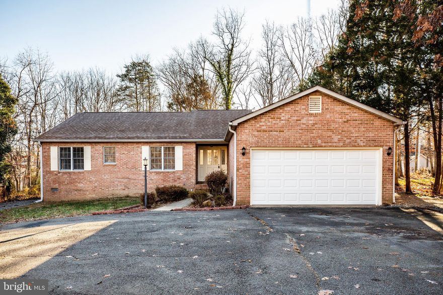 The circular drive welcomes you to this well built, freshly painted and newly carpeted brick front rambler located near the main gate of amenity-rich Lake of the Woods. You'll love the expansive room sizes, sunroom, and wood stove located in the cozy family room off of the kitchen! There's even a bonus room off of master perfect for an office or craft room! The deck is accessible from the family room and sun room and leads to a level yard perfect for outdoor relaxing. Feel like venturing out? Take a jump in the lake or pool, play a round of golf, trail ride from the Equestrian Center, or savor a fabulous meal at the Clubhouse overlooking the pristine lake. You CAN have it all!
