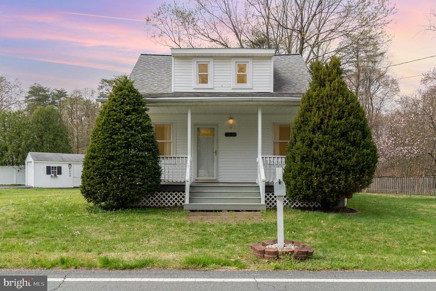 Charming Cape Cod-style home on a spacious corner lot—just 5 minutes from Fort Meade! This adorable home offers nearly 1,200 sq. ft. of beautifully updated living space, featuring new luxury vinyl plank floors, a new HVAC system and hot water heater (2023), and a roof from 2015. The main level boasts a primary suite with a private bath, plus inviting living and dining rooms with elegant arched entryways. The updated galley kitchen is a must-see as it boasts of plenty of cabinet storage and counter space! Upstairs, you'll find two well-appointed bedrooms and another full bath. A full unfinished walk-up basement provides a laundry area and plenty of extra storage. Step outside the kitchen slider to a large deck that  is perfect for outdoor enjoyment. The property also includes a huge detached garage that fits a car and a spacious storage shed. A true gem—don't miss this one!
