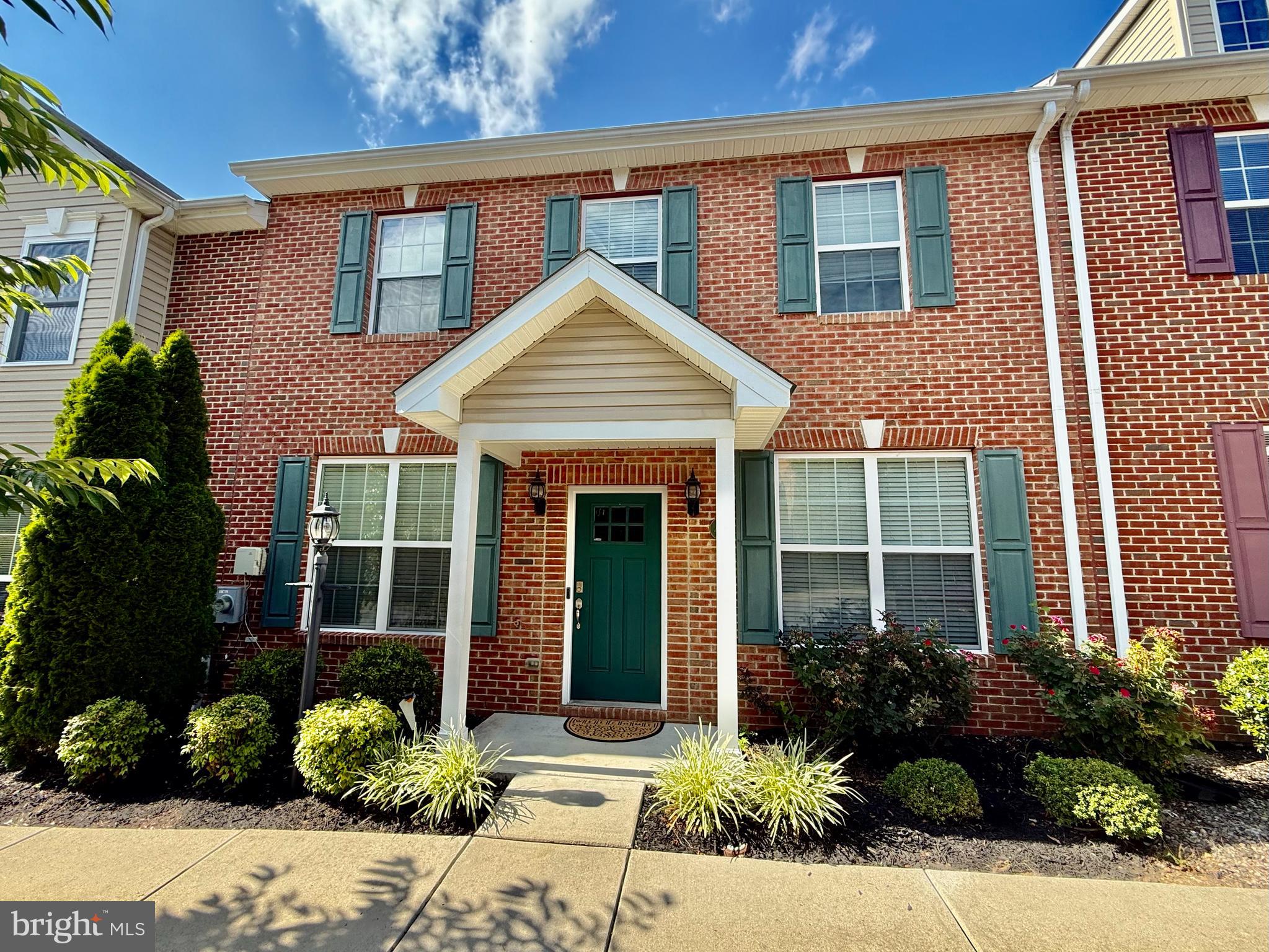Welcome to this beautifully cared-for, original-owner 2-story brick front townhome offering the perfect blend of comfort, functionality, and convenience. With 3 spacious bedrooms and 3 full bathrooms, this home is ideal for first-time buyers, those looking to downsize, or investors seeking a turnkey rental opportunity. Inside, you'll find gleaming hardwood floors throughout and a layout that maximizes both privacy and space. Upstairs features two generous bedroom suites, each with a private full bath, walk-in closet, and its own linen closet. The main-level bedroom includes French doors, a double-door closet, and direct access to a full hall bathroom—perfect for guests or a home office setup. The inviting living room offers flexibility to design and arrange to your taste. The kitchen is a standout with granite countertops, stainless steel appliances, a center island with seating, ample cabinet space, and room for a full dining area. A dedicated laundry room with built-in shelving and extra walk-in storage under the main stairwell adds even more functionality. Step outside through the sliding glass door to your private patio and yard—a great space to relax or entertain. Enjoy peace of mind with 2 assigned parking spaces right in front, plus additional visitor parking. The HOA takes care of all front landscaping and rear yard maintenance, keeping everything looking pristine year-round. Don't miss this fantastic opportunity to own a well-maintained home in a sought-after location—just minutes from shopping, dining, and everything La Plata has to offer!