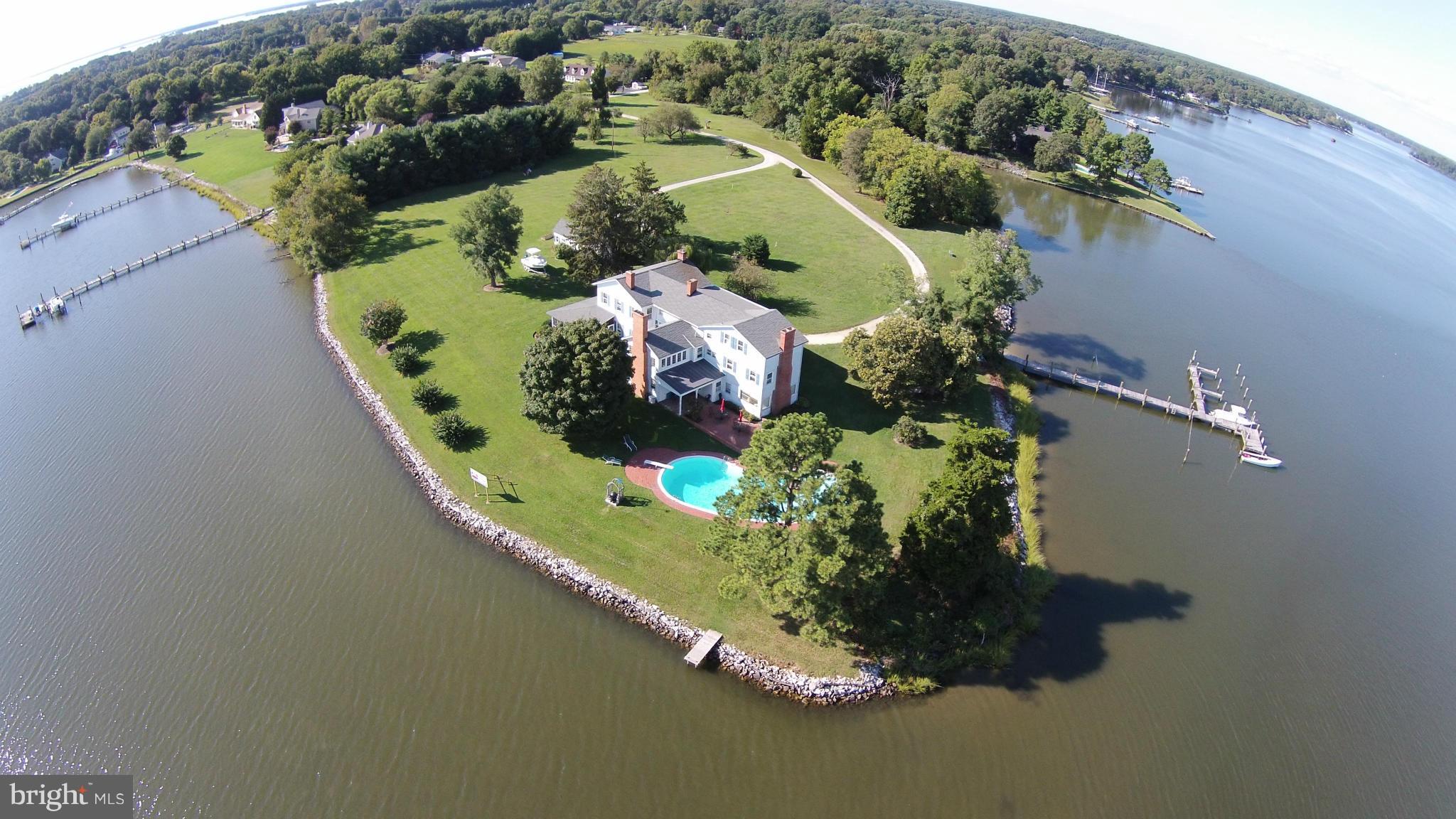 This home sits on one of the most awesome points of land on the entire Wye River. The water views can be seen from every window of this home and are over 270 degrees. The large pool sits on the point and is over 11' deep with a diving board. The property has been perked and will support a subdivision of one additional waterfront lot on either side. The 7' deep water pier has slips for 7 boats.