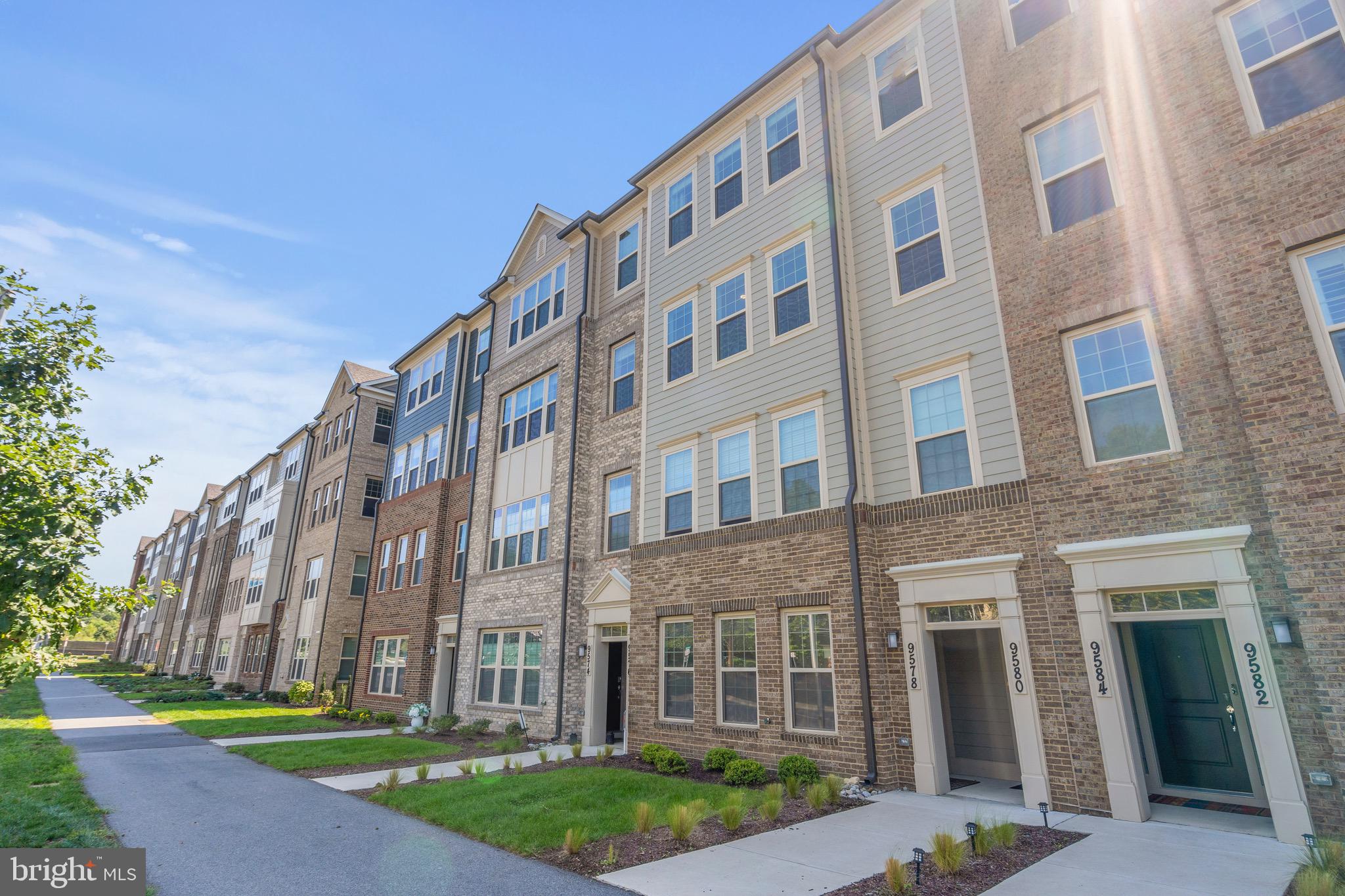 Welcome to the pinnacle of urban suburban living in the heart of Downtown Crown. This bright, expansive, and highly sought-after “Sydney” model, built in 2021 by Pulte Homes, combines upscale design and convenience as a matter of lifestyle! Boasting 3 Bedrooms + a large den and over 2,500 sq ft, this home is generous in space and deceptively large.
The main floor offers bright, open sight-lines across the living and dining spaces, with southern exposures drenching the home in natural light throughout the day. Gleaming wide plank hardwood floors on the main level invite you to sit at your massive, 10-foot eat-in island, with quartz countertops. A spectacular Kitchen-Aid appliance suite with a gas-fired range and externally exhausted fume hood top off this luxury kitchen. A large main floor office/den, a proper walk-in pantry, powder room, and a party-sized deck off the kitchen/rear of the home complete the main level. On the second level, the oversized and light-filled primary suite contains two large walk-in closets and a lovely, spa-like en-suite bathroom with floor-to-ceiling tiles, high-end quartz countertops, glass shower enclosure, and separate water closet. Two additional large, sun-filled, and king-sized bedrooms along with an expansive bathroom on the second level, allow this property to lend the comforts and size of a detached property, without the maintenance involved. Additional enhancements include LED recessed lighting on the main level and custom window treatments throughout. Secured parking and direct access to the home from your garage make life even easier.
This community is conveniently located just a short walk to Downtown Crown and less than a mile from Rio Washingtonian Center — both of which feature award-winning upscale bars and restaurants, shops, grocery stores, and gyms. The Retreat at the Crown Community Center also offers residents the opportunity to partake in community events, access outdoor pools, sport courts, playing fields, and gyms. For errands outside of the community, enjoy easy access to all major commuter routes including Rt.270 and Rt.200 at your doorstep. Don’t miss the opportunity to make this beautiful home and lifestyle yours!