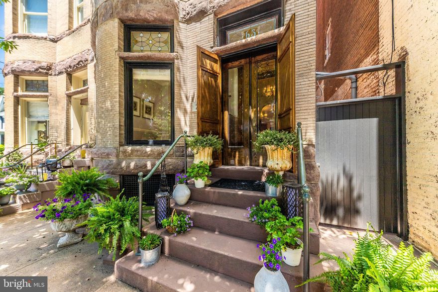 In the heart of Historic Downtown Frederick, Maryland, a city celebrated for its rich cultural heritage and walkable charm, stands what can only be described as the crown jewel of Historic Frederick. PLEASE BE SURE TO WATCH THE VIDEO FOR THIS LISTING! IT IS AMAZING! 203 East 2nd Street is a rare and architecturally significant Brownstone, originally constructed in the late nineteenth century and designed in the Dempwolf style by renowned architect Joseph Dempwolf. Showcasing Romanesque and Renaissance Revival influences, the home’s intricate brick façade and carved millwork reflect the craftsmanship of a bygone era. Offering over 4,200 square feet above grade across three full levels and a full basement, this five-bedroom, five and one half bath residence balances historic authenticity with modern luxury. The second-floor bathrooms feature radiant heated floors and heated towel racks, while all bathrooms are outfitted with floating vanities, refined tilework, and designer fixtures. Bedrooms include ceiling fans, generous windows, custom lighting, and Mitsubishi split systems for zoned climate control. The sixth bedroom has been converted into a luxury dressing room with gas log fireplace, built-in closet systems, and a marble-topped island, and can easily revert to bedroom use. Historic details include original tile, wood floors, chestnut pocket doors, and two wood-burning fireplaces. The 2023 gourmet kitchen offers GE Café appliances, a porcelain farmhouse sink, solid surface backsplash, concealed outlets, and a white oak pocket door crafted by Hicksville Plannery. Utilities are pre-routed for a future elevator. The fully hardscaped backyard features a brick patio, wood decking, a vertical garden, water feature, and a gazebo, with a detached two-car garage and finished studio above, accessed via Austin Alley. The basement includes a second laundry area and abundant storage. Originally owned by Jacob Rosenstock and later the Lebherz family of Everedy Square, this property has been a cornerstone of Frederick’s architectural and entrepreneurial legacy for over a century. 203 East 2nd Street is more than a home. It is where historic integrity meets the highest standard of modern living. Timeless, elegant, and truly unforgettable.