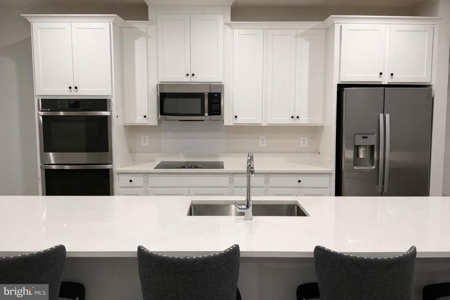 Built in 2023 by Stanley Martin, this move-in-ready townhome-style condominium offers modern design, thoughtful finishes, and immediate availability in the heart of Herndon. With 3 bedrooms and 2.5 bathrooms, the home is filled with natural light and features 9-foot ceilings, recessed lighting, and a bright, open-concept layout designed for comfortable everyday living.

The main level showcases a well-appointed kitchen with stainless steel appliances, an oversized island, generous cabinet space, and a large pantry, flowing seamlessly into the living and dining areas. The layout is both functional and inviting, ideal for daily living and entertaining.

Upstairs, the home offers three generously sized bedrooms, including a spacious primary suite with a large walk-in closet and a private bathroom with dual vanities and modern finishes. All spaces have been completed and well maintained, allowing the next owner to move in without additional work or wait time.

Conveniently located near Dulles Airport, the Silver Line Metro, and major commuter routes, the property also offers easy access to nearby shopping, dining, and everyday conveniences. This nearly new, move-in-ready home presents a rare opportunity to enjoy modern living in a prime Herndon location.
Perfectly positioned for commuters, this home is just minutes from Dulles International Airport, the Silver Line Metro, and major commuter routes, with shopping, dining, and daily conveniences within walking distance.