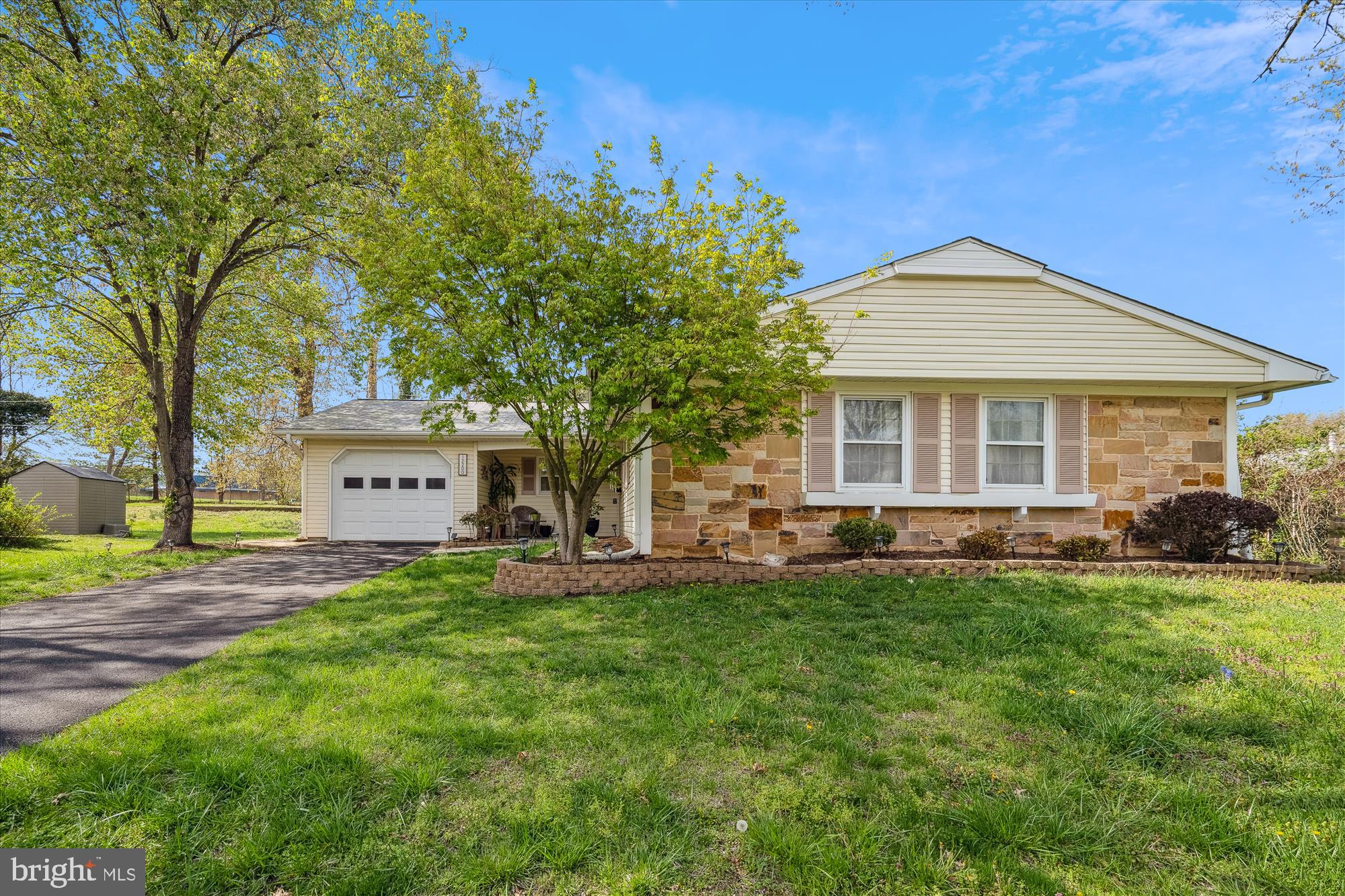 Bowie's best rambler with large rear addition featuring vaulted ceilings, brick hearth fireplace, built-in bar and door to the rear yard. The covered front porch leads to the foyer of the home with large coat closet. Updated table space kitchen features stylish cabinets, part butcher block countertop and electric range with tiled backsplash. Enter through the garage into the mudroom/laundry room into the kitchen. Spacious separate dining room and living room area lead to the huge rear addition. Primary bedroom with custom designed closet and ensuite full bathroom. Two additional bedrooms share the second full bathroom in the hallway. Fresh paint and new carpet throughout this extremely well maintained home. Generac generator conveys.Plenty of parking in the freshly resurfaced driveway and the one car garage. Level rear yard with patio too! A must see!