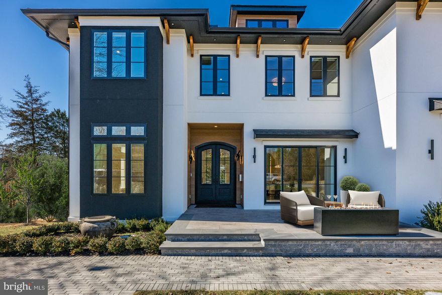 Experience contemporary elegance in this custom-built home by CRT Builders, with exquisite landscaping by Charles Owen of Fine Landscaping. Nestled in a prime location within walking distance of grocery stores, restaurants, top-rated schools, and parks, this residence offers both convenience and modern luxury. A charming front patio with a fireplace welcomes you, setting the stage for the inviting interiors. Inside, the foyer opens to a sophisticated library with custom built-ins and a formal dining room, where sliding glass doors seamlessly blend indoor and outdoor living. The beautifully designed butler’s pantry, complete with a beverage cooler, connects the dining area to a chef’s dream kitchen. Outfitted with top-of-the-line appliances, custom cabinetry, an integrated walnut dining table, and an oversized kitchen island, this space is both functional and stunning. Adjacent to the kitchen, a sunlit morning room with built-ins and the spacious family room that features a cozy fireplace, built-ins, and sliding glass doors leading to an expansive deck with a built-in outdoor kitchen-ideal for entertaining. Upstairs, the luxurious owner’s suite boasts a fireplace, two custom walk-in closets, and a spa-like bath with dual vanities, a freestanding tub, heated flooring, a heated towel rack, and a large marble double shower with a Steamist generator and touchscreen controls. Four additional ensuite bedrooms and a family sitting room with built-ins and a beverage chiller complete the upper level. The walk-out lower level is designed for entertainment and wellness, featuring a home theater, a fitness room with commercial-grade impact flooring, a wet bar with a temperature-controlled wine cellar and showcase window, plus a guest bedroom and full bath. Outside, the fully fenced backyard is a private retreat with a six-person hot tub, a gas fire pit, and a charming potting shed equipped with a half bath, potting table, and garden sink. Additional features include a ans elevator, whole-house generator, rooftop solar panels, and a three-car garage pre-wired for a 60-amp Tesla charger, with an extra-tall bay designed to accommodate an RV or a garage lift for two vehicles. Blending modern innovation with timeless elegance, this exceptional home offers an unparalleled living experience in the heart of McLean.