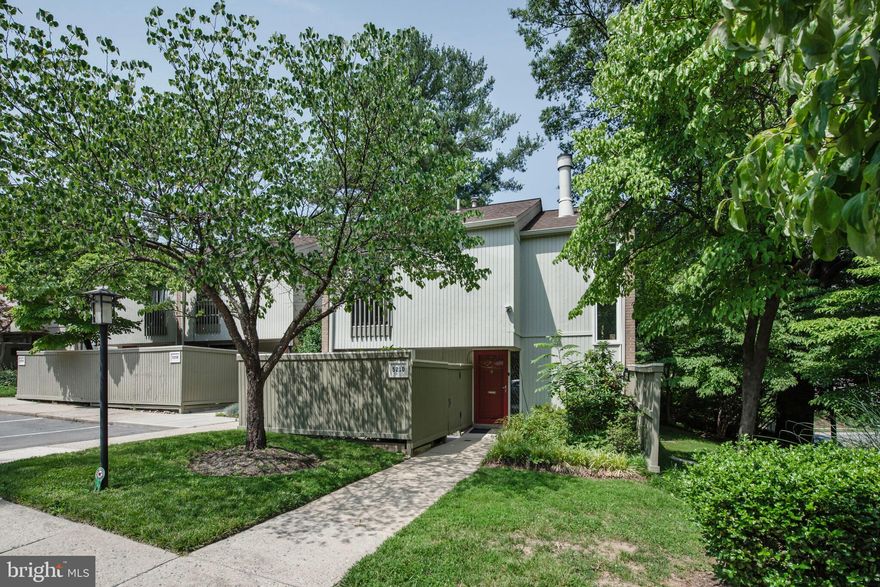 This lovely CORNER townhome blends classic Mid-Century design with thoughtful updates on three  levels, featuring  3 bedrooms, 3.5 bathrooms and a  4th potential bedroom  in the basement with window  ! The main level features a delightful  living and dining area with exposed brick wall, gleaming hardwood floors throughout, a cozy wood-burning fireplace, and access to  a spacious flagstone terrace , perfect for indoor-outdoor living. The kitchen offers granite countertops, stainless steel appliances, and a cheerful breakfast nook that opens directly to the front patio, ideal for morning coffee or casual dining. Upstairs, the primary suite offers a private retreat with its own balcony, a walk-in closet, and an updated bath. Two additional bedrooms and a second full bath complete the upper level, all with hardwood floors and plenty of natural light. The fully finished lower level adds flexibility with a spacious recreation  room, a fourth bedroom, full bath, laundry, and an additional window! Wonderful space for guests, a home office and additional living space! Tucked just behind Maplewood-Alta Vista Park, this home offers easy access to scenic trails, a community pool, and peaceful green spaces. Less than 1 Mile from  French school! It is situated between NIH and Grosvenor Metro, and just minutes from the Beltway...it's a commuter’s dream!