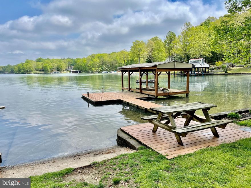 FINAL PRICE IMPROVEMENT! on this incredible opportunity for investors and/or Lake Anna enthusiasts! This custom timber framed lakefront home was built for lake life and large groups. The wall of windows with vaulted ceilings welcomes you with an immediate WOW factor! along with a rustic stone fireplace, gourmet kitchen with bar, stone countertops and upgraded appliances. You will love the luxury Master Suite with custom tile shower and the recently renovated lower level features an additional bedroom and large rec space overlooking the lake w/ foosball table & TV. From there, walk right out to the like new 8-person Hot Springs Hot Tub and down to your own private deep water dock with boat ramp and boat slip! Great location by boat or land, close to wineries, restaurants & grocery. Short-term rentals grossing nearly $200k/year! Furnishings & Rentals can convey.