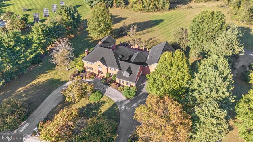 Experience the Majestic Grandeur of this Solid Brick Estate in the heart of Howard County, MD
This stunning all-brick estate, located at 13009 Twelve Tree Ct, Clarksville, MD 21029, offers an expansive living space of almost 11,000 square feet spread across all three levels. Set on a generous 3.10-acre lot near the end of a cul de sac, the home provides an incredible amount of privacy & space for both relaxation and entertainment. Built in 1989, this 35-year-old residence has been meticulously maintained, featuring recent updates that make it feel both modern & timeless. One of the highlights of the property is the large, heated indoor pool, measuring 20 x 40 feet and housed within a 40 x 60-foot room. Whether for swimming laps or simply lounging poolside, this feature offers year-round enjoyment, regardless of the weather. For vehicle enthusiasts or families with multiple cars, the large, three-car side-load garage provides ample parking and storage space. The home also features a circular driveway for easy access & additional parking. Outdoor spaces are equally impressive, with an extra large all brick patio surrounded by stately brick pillars & expansive views of the vast backyard, bordered by mature trees and a majestic weeping willow. With a large outdoor fireplace, grill & entertaining area, the patio offers ample space for outdoor dining & relaxation, with plenty of room to accommodate even the largest of outdoor gatherings with ease. The heart of the home is a sunny and open Gourmet eat-in Kitchen with multiple seating options including a large breakfast bar & table space for family or guests. Elegant white cabinetry offers plentiful kitchen storage options & is richly accented by high end Granite countertops & a custom backsplash. The kitchen provides direct access to the spectacular outdoor patio & the enclosed pool pavilion, making it ideal for effortless indoor-outdoor entertaining. A full bedroom & bath are located off the side of the kitchen as are the laundry area and direct entrance to the 3 car garage. A noted benefit of the home is a sloped brick ramp that leads from the main level bedroom/office area to the back patio for easy access to the patio & backyard areas for persons with mobility issues or those using a wheelchair or walker. With seven bedrooms & six-and-a-half bathrooms—many of which were renovated just five years ago—this home is well-suited for large families or those who frequently entertain guests. The interior boasts two fireplaces, adding warmth & charm throughout the home. The great room on the main floor is ideal for gatherings, with its open layout creating a welcoming atmosphere for friends & family. The great room, kitchen, bedroom & pool pavilion all feature direct access to the oversized patio, allowing the interior living areas to easily blend into the outside to seamlessly extend the useful living area of the home. In addition to the main Master Suite, which includes a sitting room & side balcony overlooking the vast backyard,  there is a second Master Bedroom, offering an additional private suite for guests. The property is further enhanced by a home office or library, providing a quiet space for work or study, and hardwood floors throughout the main & second levels,. The fully finished basement features a bonus room, full bathroom, multiple open recreation rooms & walkup stairs for easy access to the backyard. Additionally, this home benefits from a four-zone air conditioning system, ensuring comfort throughout the seasons. Additional updates include a six-year-old roof, recently updated air conditioning systems, & a new pool cover, ensuring peace of mind for the new owners. This home represents the perfect blend of luxury, comfort, and practicality, ideal for those seeking a spacious retreat in the heart of Howard County. Whether you are looking for a home to entertain guests, raise a family, or simply enjoy the finer things in life, this Clarksville property offers it all!