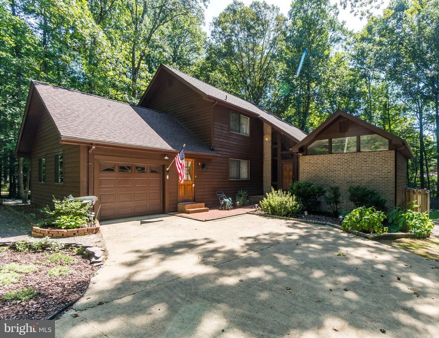 40' x 30' Detached garage w/ 12' ceilings & 10' center bay door for the car enthusiast..  Roof, Gutter Guards, Stained & wrapped  facia & rack in 2018, Newer HWH and A/C 2014.  Spacious kitchen with lots of prep area including extra prep sink and additional full size oven.  Lots of natural wood and wonderful windows to enjoy the view of the large, private backyard with over sized deck.