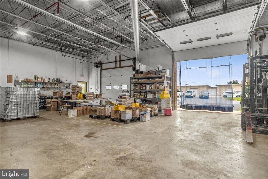 Currently a Distillery.  Large Open Warehouse Space with 1 Dock Door, 1 Drive-In Door.  Doors have Electric Roll-Up Door, Three Phase Electric & Shared with one other Tenant Separate Mens and Womens Restrooms. Adjacent to Frederick Airport.