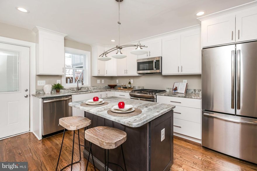 1800 SQFT of Finished Space in this 4 BEDROOM rowhome with 2 CAR PARKING - All 4 bedrooms are on the upper levels with 3 full baths/2 half baths. High-end finishes throughout, hardwood floors on all levels, stainless steel appliances, granite counters, custom tile, 2 Master Suites, & roof deck overlooking the stadium with city views! Walking distance to Riverside Park & Thomas Johnson Elem/Middle.