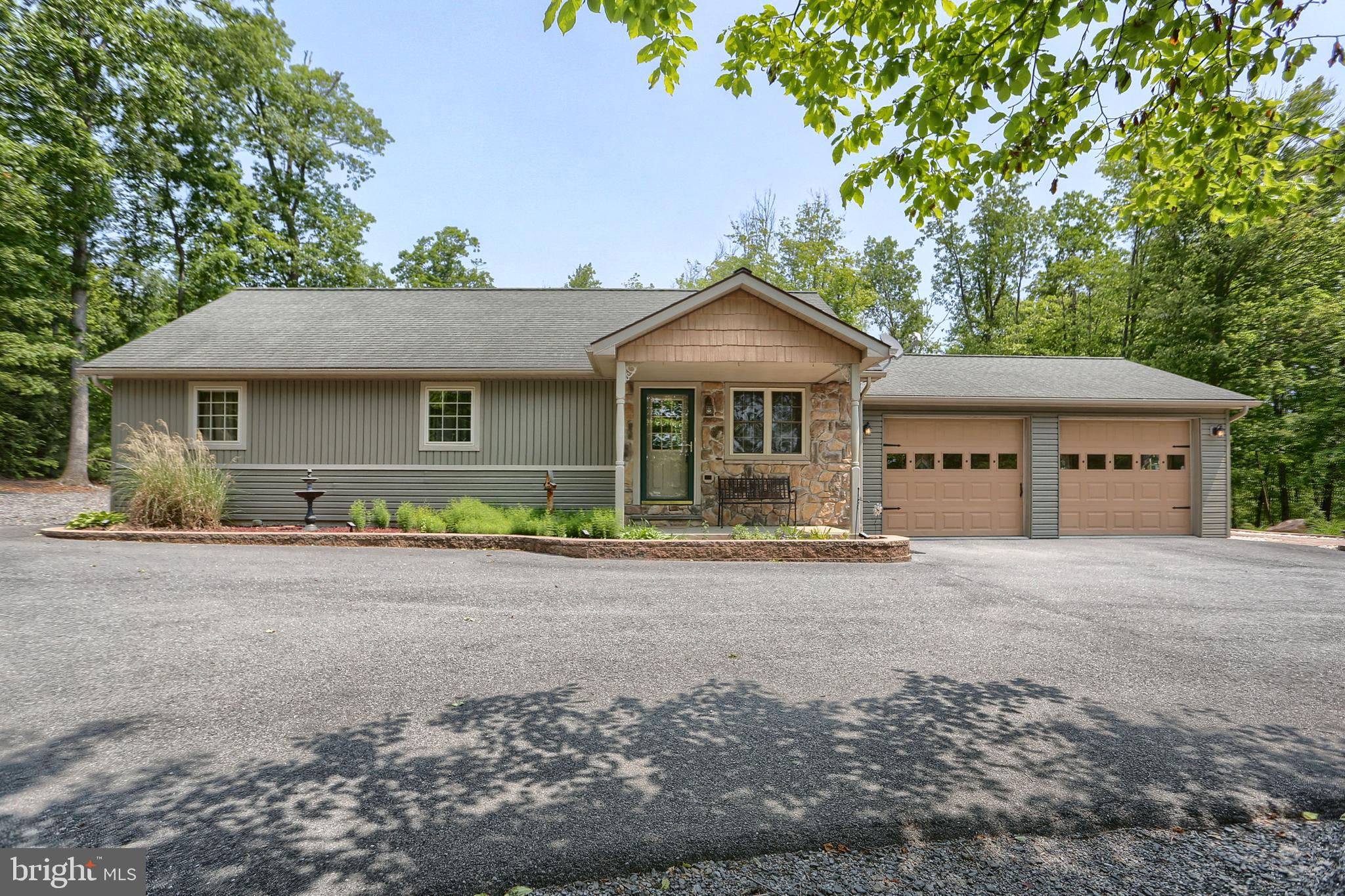 Do you like to entertain or just enjoy being outside, this is it. The walk ways, patio areas and covered porches are beautiful and in excellent condition. The stainless BBQ grill and workspace has been used very little & is just waiting for the cook/chef in the family! This home has been cared for and loved and will be evident as you take a look around. The setting is relaxing and gives you both woods and cleared. There is so much to like including the geo-thermal heat/air which in turn keeps the utility bills low. Poured concrete and insulated walls are what you find in the basement. The basement shelving unit will remain as will the unit on the rear porch that can house a TV and there is a cable hookup. You and your guests can relax outside and watch the game, listen to music or whatever you are in the mood for! There is a propane wall heater in the garage and basement. The shed has electric and you have a Generac whole house generator so you can relax when the power goes out! There are stairs to the attic in the house and an access hole in the garage. If needed there is storage throught the middle of the attic. Do not miss the opportunity to see this very special home.