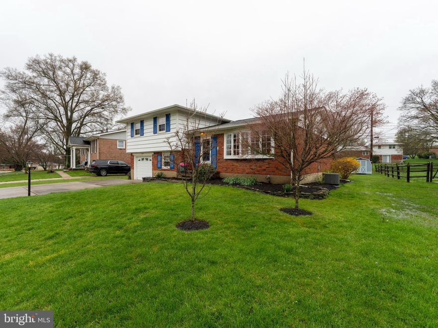 Nestled in the heart of Timonium, this meticulously maintained and cared for 4 BR 2 1/2 bath split level with a one car garage and a level lot has over 2600 square feet of living space and is in walking distance to the community pool and common area of SpringLake.  As you enter the home there are added coat closets in the foyer offering desired storage for outerwear, bags, and shoes.  The living room and Dining room are adjacent to the foyer and have beautiful hardwood floors and a large bay window overlooking the front yard.  The dining room is large and is next to the expanded kitchen.  The kitchen has updated quartz counters and undermount sink, laminate pergo like flooring, a center island work station and built in pantry that will stay with the house, and room for a kitchen table and chairs.  Crown Molding is installed in nearly every room of the house which offers a finishing touch to each space. Upstairs are three bedrooms and two baths with hardwood flooring throughout and tiled floors in the baths. The Hall bath is updated and also has a  stacked washer/dryer.  Laundry on the Bedroom Level!  The primary bedroom is large and has its own private full bathroom with a beautiful pedestal sink and custom tiles in the shower.  On the lower level is a large family room with a beautiful gas fireplace with an included firescreen and custom molding.  The floors are luxury vinyl plank and there is plenty of room for entertaining.  Also on this level is a 4th bedroom and a half bath.  The 4th bedroom furniture is included in the sale. Direct access to the garage is on this level; lots of storage shelves are included in the garage for the next owner. The garage holds one car and the driveway is double wide to hold four more cars.    A four season room addition is also on this level offering a sun filled area with heat and air.  The heaters are new. The addition has beautiful red tiled floors and the door to the back yard leads to the large patio. Outside is a large gazebo and patio that were just added in 2022-2023 offering a place to entertain outside.  The large level lot is perfect for yard games or gardening and is already beautifully landscaped. One more level to this home is a huge play room/man cave/party room with new luxury vinyl plank flooring, a retro bar with storage, included stools, and an included pool table.  The room also has a large sitting area for watching TV or just hanging out with friends and family.    The HVAC was replaced in 2022, Water Heater replaced in 2023, Gutters and downspouts replaced 10 years ago, Sump pump is 2023, garbage disposal was replaced in 2023. The Springlake community has a pool that neighbors can join from year to year for a fee. The community has certain covenants and restrictions regarding fences and other structures that need approval before an owner completes.  The neighborhood association offers neighborhood parties, maintenance of the entrance gardens, seasonal decorations, community cleanup, and pond maintenance. There is an optional $50 /year association fee.