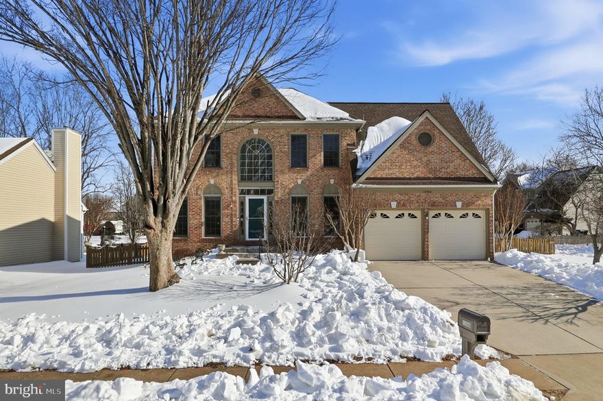 Welcome to 13566 Cobra Drive, a beautifully maintained brick-front colonial nestled in the sought-after Chantilly Highlands community of Herndon. This spacious home offers 4 bedrooms, 3.5 bathrooms, and approximately 2,671 finished square feet across three thoughtfully designed levels—perfect for both everyday living and entertaining.

The main level welcomes you with a bright, two-story foyer and gleaming hardwood floors. A formal living room and elegant dining room provide classic entertaining spaces. The light-filled kitchen features warm wood cabinetry, stainless steel appliances, and a sunny breakfast nook. The adjacent family room is anchored by a cozy fireplace and soaring ceilings, creating an inviting space to gather and relax. Access to the large deck with an awning, perfect for those sunny days.  A convenient main-level laundry room/mud room off the garage adds everyday ease.

Upstairs, the spacious primary suite offers a peaceful retreat with a private en-suite bath with dual sink vanity, soaking tub, shower stall, and a walk-in closet. Three additional well-proportioned bedrooms and a full hall bath complete the upper level. 

The finished lower level expands your living space with a large recreation room, wet bar, full bathroom, and an additional room ideal for guests, a home office, or gym.  There is a crawl space for storage. 

Outside, enjoy a fenced backyard and deck, perfect for outdoor dining or relaxing evenings. A two-car garage, mature landscaping, and the original owner's pride of ownership complete the package.

Ideally located near parks, trails, shopping, dining, commuter routes, and top-rated Fairfax County schools, this home offers space, comfort, and convenience in a community known for its amenities and neighborhood feel. 

Updates include: Fresh paint throughout and new carpet in 2026; Deck painted in 2025; HVAC and Water Heater replaced in 2023; Roof replaced in 2010; Anderson Windows installed in 2010; Kitchen remodeled in 2016, including cabinets, granite, tile backsplash, and appliances; Refrigerator 2023.